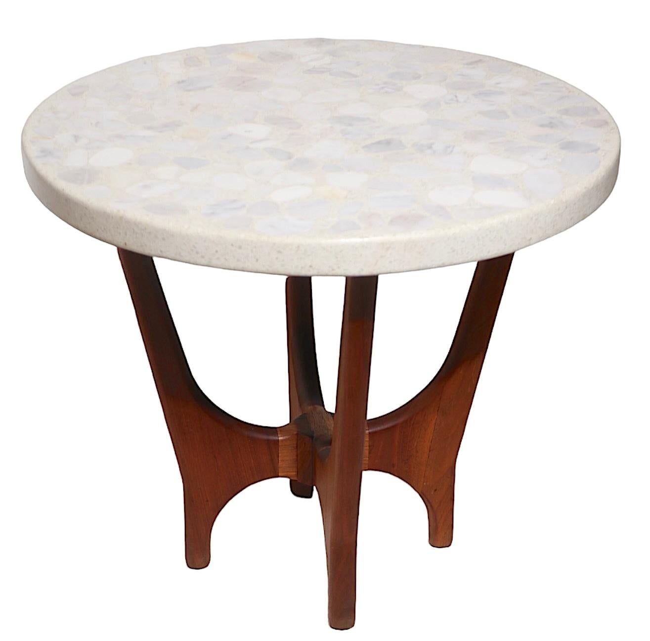 Chic Mid Century side, or end table designed by Harvey Probber circa 1960's. The table features a thick ( 1.75 inch ) round top composed of marble, onyx, and terrazzo, with a stylized  sculptural solid walnut base. This example is in very fine,