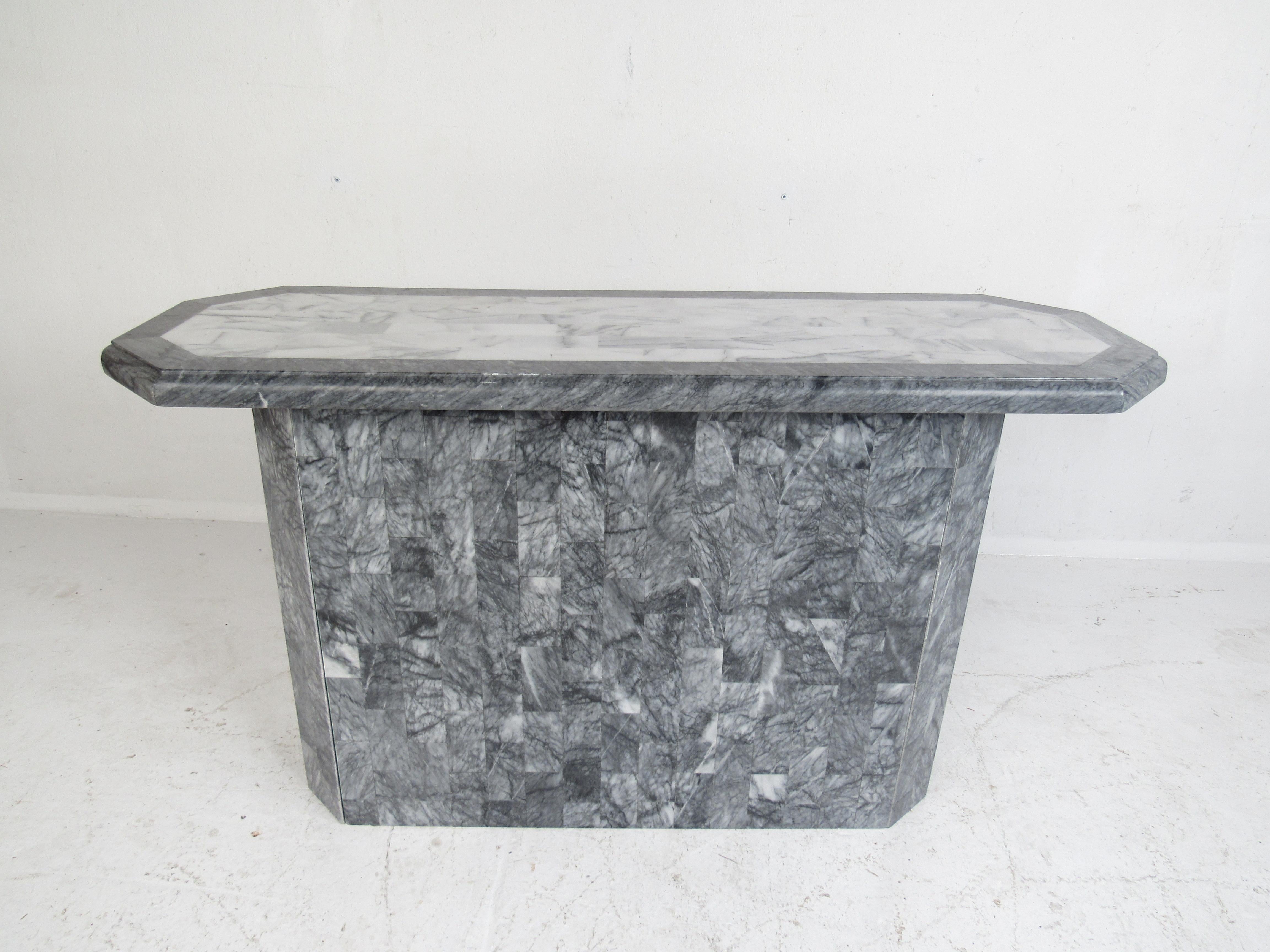 A stunning two-tone design with light and dark grey tessellated stone. This vintage modern hall table features an unusually shaped top with beveled edges. This versatile piece looks great behind the sofa, in the hallway or in any entryway. Maitland