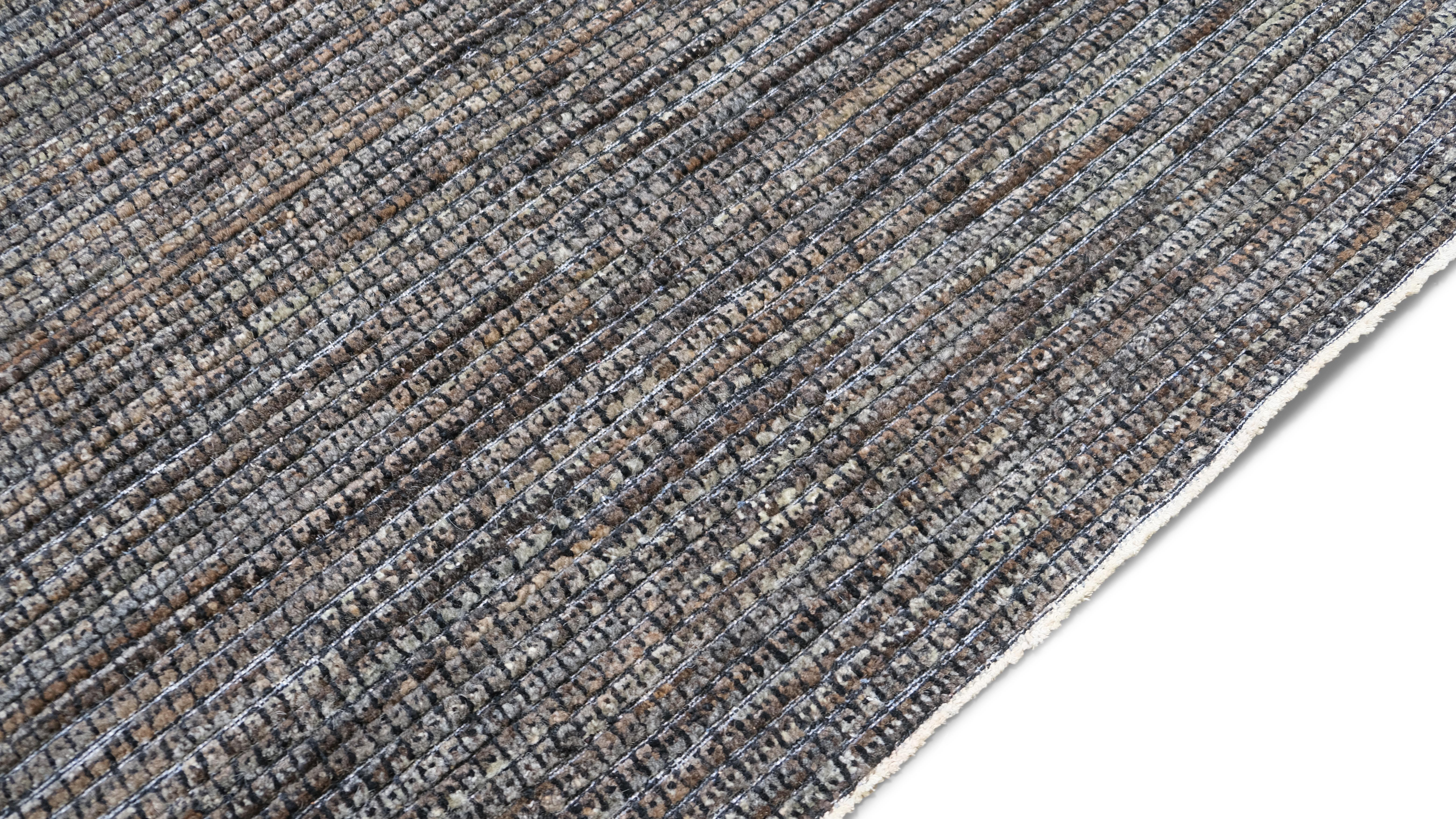 Featuring a minimalist textured design in rich gray brown tones, this rug is the epitome of contemporary sophistication. Its subtle texture and tonal variations create a sense of depth, making it a versatile and timeless piece that complements