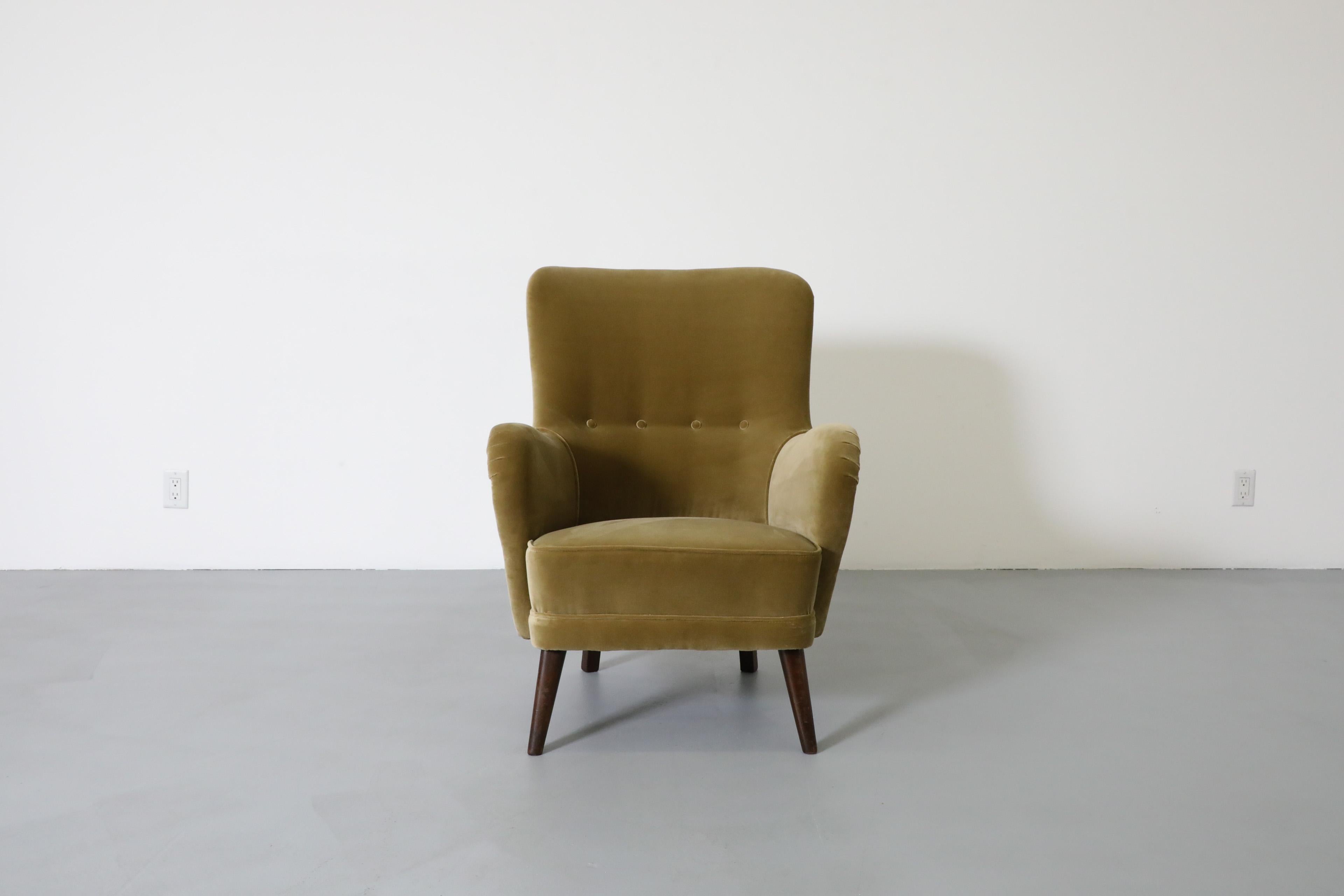 Beautiful Dutch Mid-Century high back velvet lounge chair.  A design by Dutch Mid-Century great Theo Ruth. An attractive  lounge or side chair with stylish curves and gorgeous earthy green leaf toned velvet on tapered teak feet. Newly upholstered