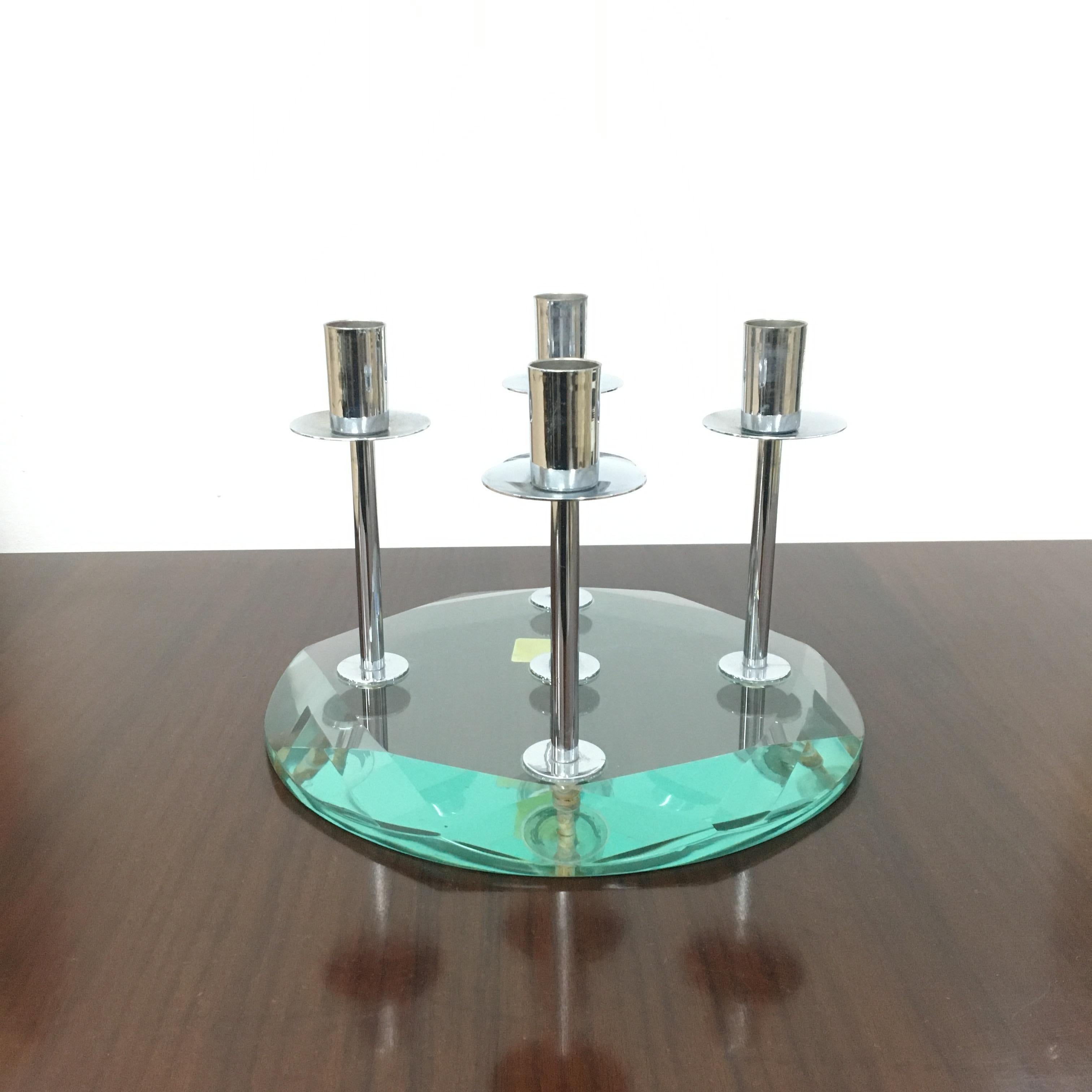 Prestigious candelabra in very thick faceted glass, Nile green color, with five candle holders in chromed metal. By Fontana Arte, 1960s, Italy. Jewelry label on the bottom.
Wear consistent with age and use.
 