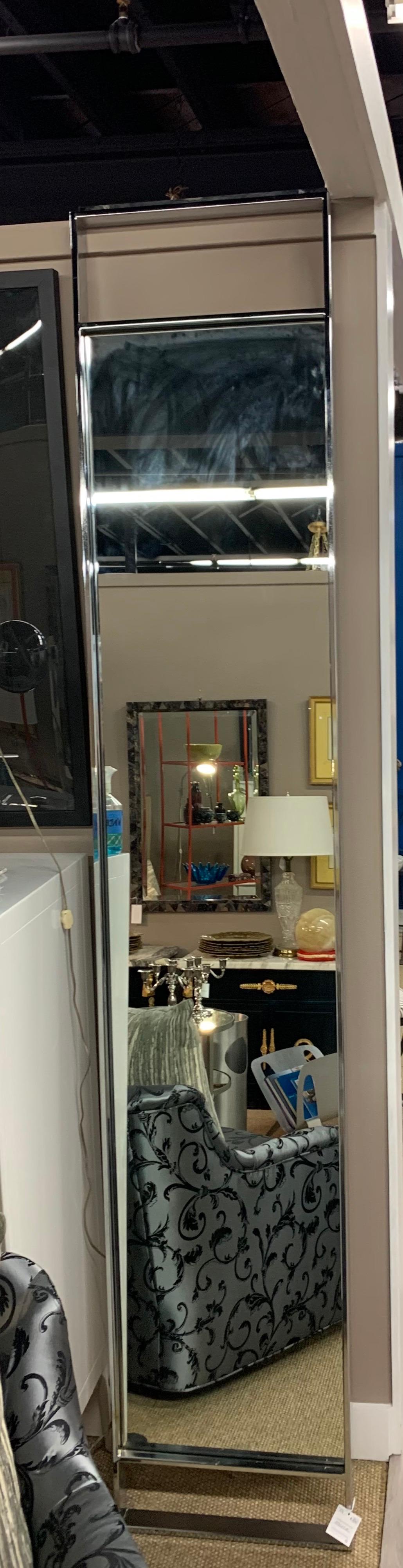 Sleek and slender chrome mirror measuring eight feet tall. Iconic mid century lines. Great scale. It is made to feature the mirror in the middle and sculptural chrome at top and bottom - see pics. Now, more than ever, home is where the heart is.