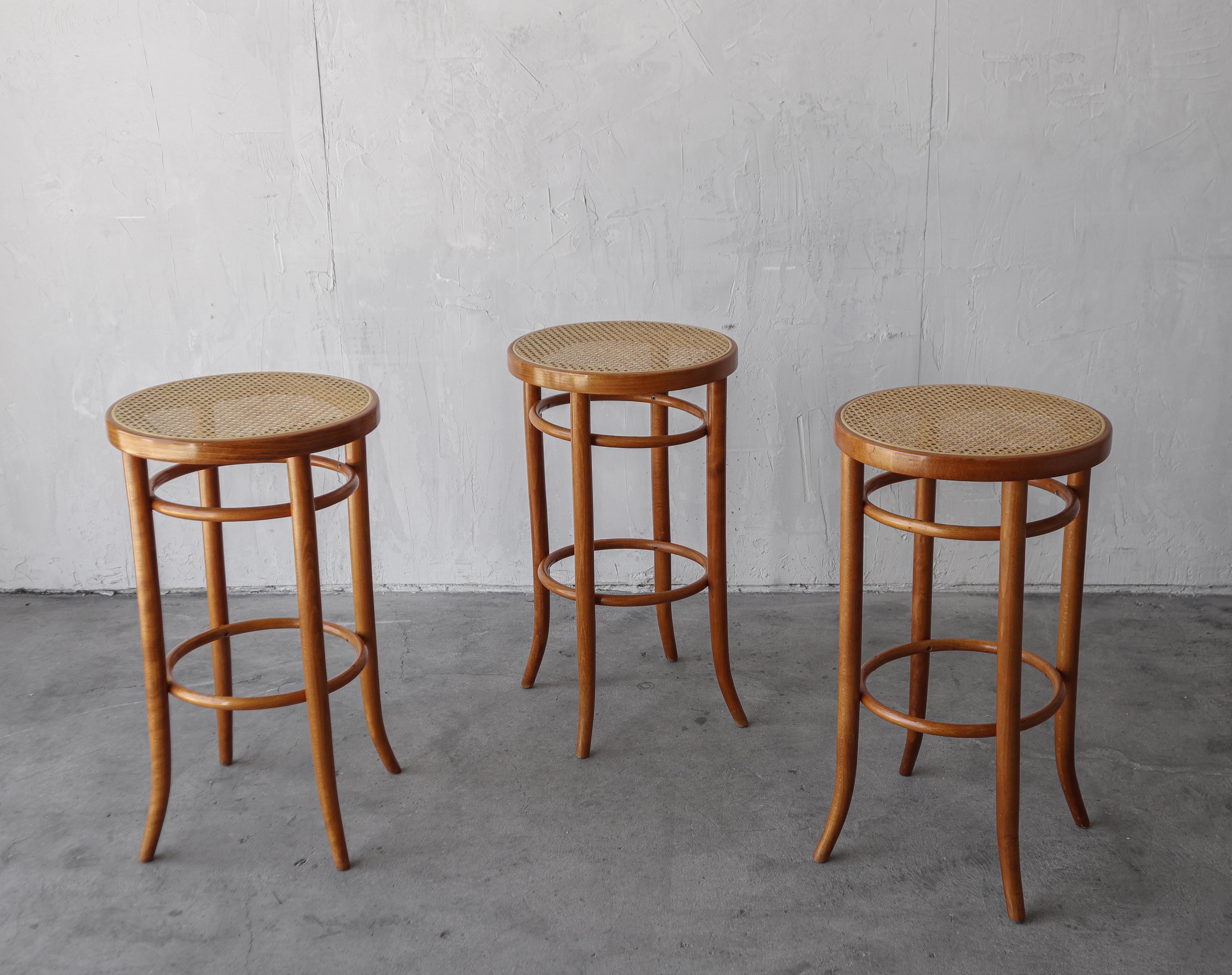 Nice set of 3 mid century bentwood stools with cane seats.

Stools are in excellent condition with no damage to be noted.  

**There is a 4th stool with cane damage that can be included for no additional charge.