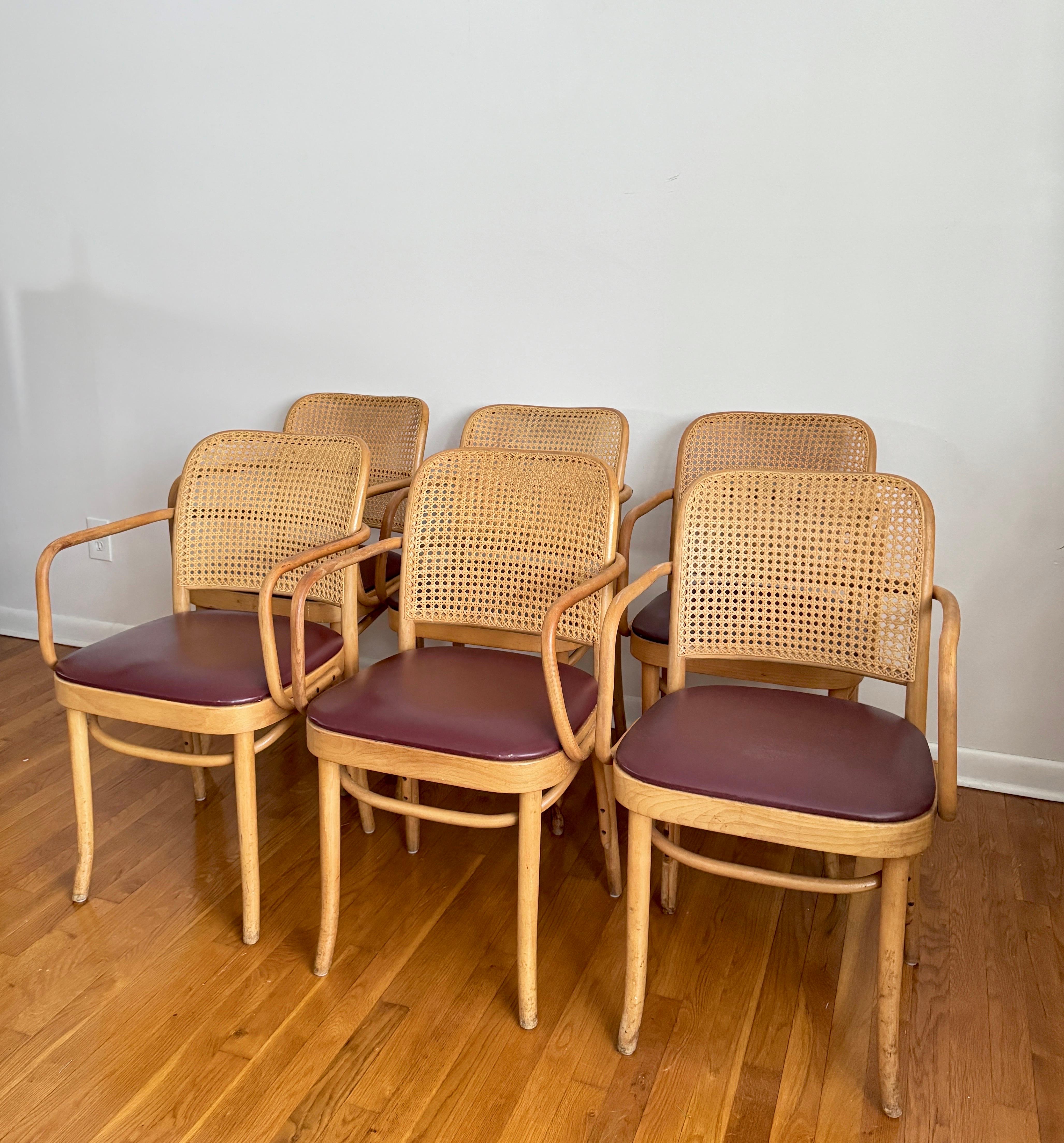 A set of 4 charming dining chairs made of rustic oak with rush seats. These chairs feature ladder-style backs. They are meticulously handcrafted, showcasing a simple yet elegant style with a touch of modern organic aesthetics. less