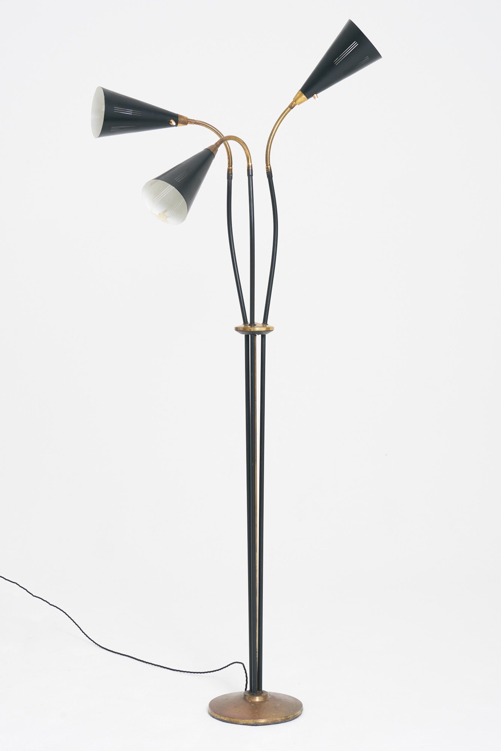 A brass and black enamelled iron three-arm floor lamp
Sweden, third quarter of the 20th Century
