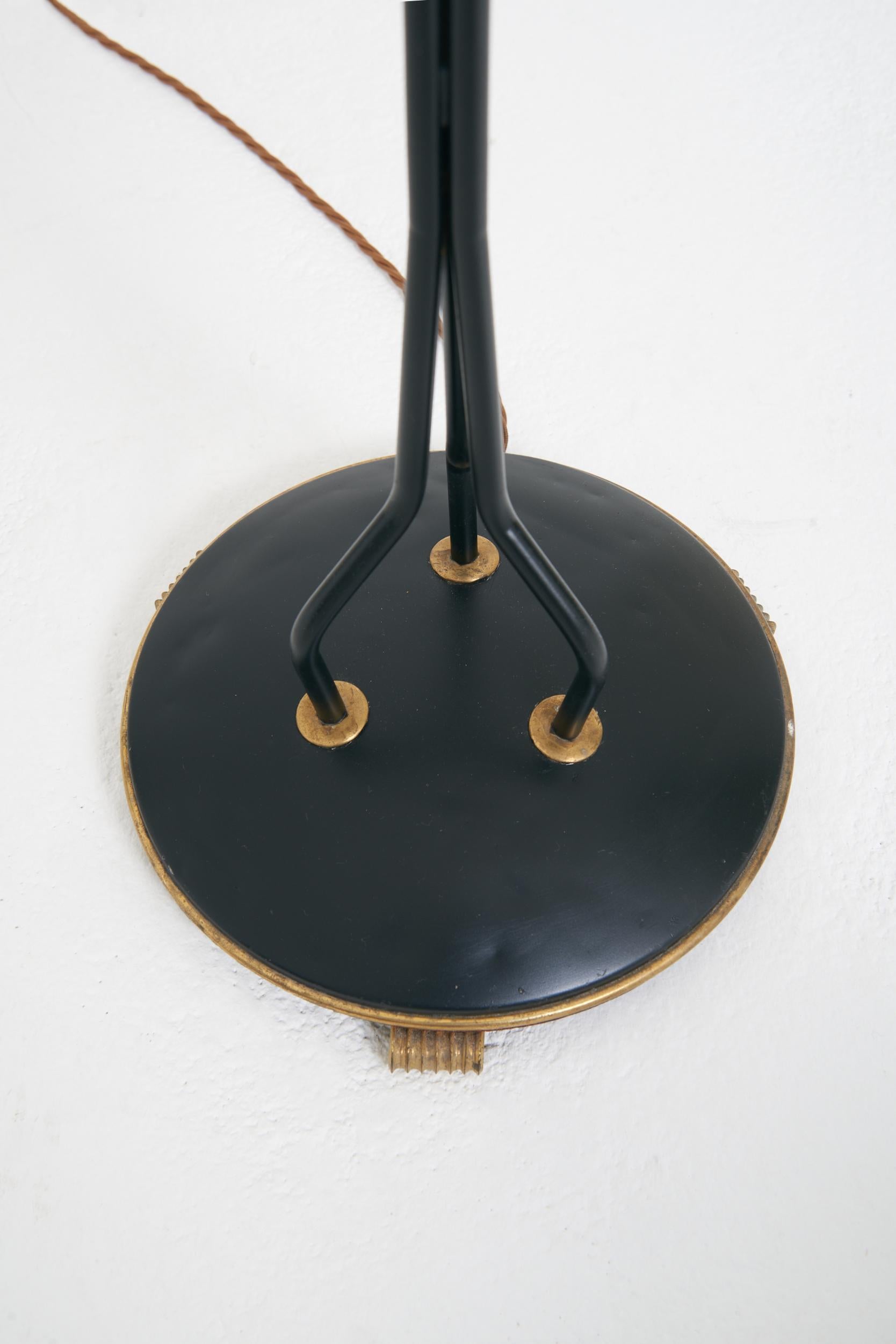 A brass and black enamelled iron three-arm floor lamp
Sweden, third quarter of the 20th Century
With the shades: 154 cm high by 86 cm wide by 76 cm depth
Lamp base only: 154 cm high by 40 cm wide by 36 cm depth
