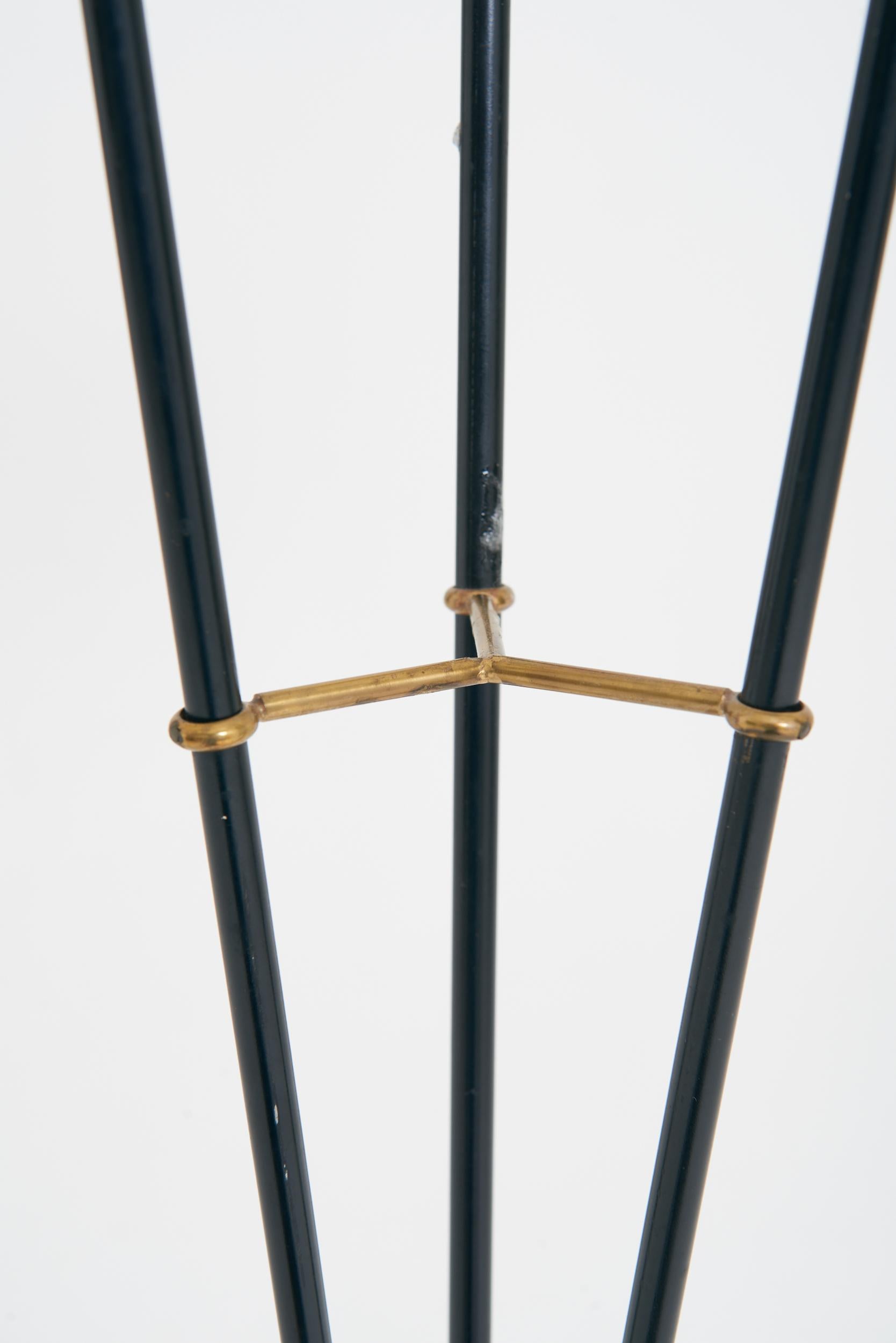 A brass and black enamel three-arm floor lamp
Sweden, mid 20th Century
With the shades: 149 cm high by 88 cm wide by 79 cm depth
Lamp base only: 131 cm high by 53 cm wide by 49 cm depth