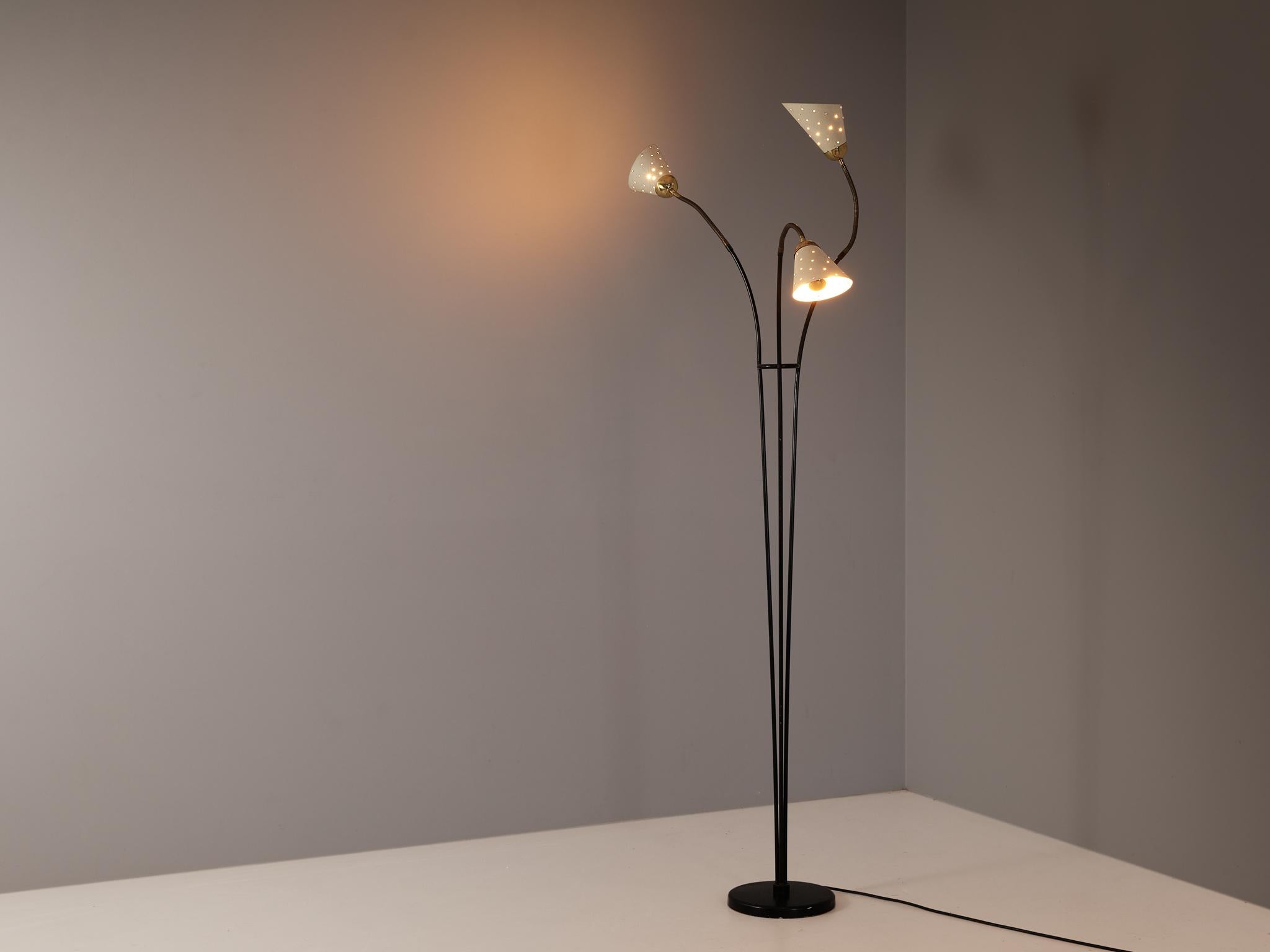 Floor lamp, brass, metal, aluminum, Europe, 1950s. 

A floor lamp with three gracefully extended arms. Its design showcases a round base lacquered in black, from which three slender stems gracefully emerge. The upper sections of the stems and shade