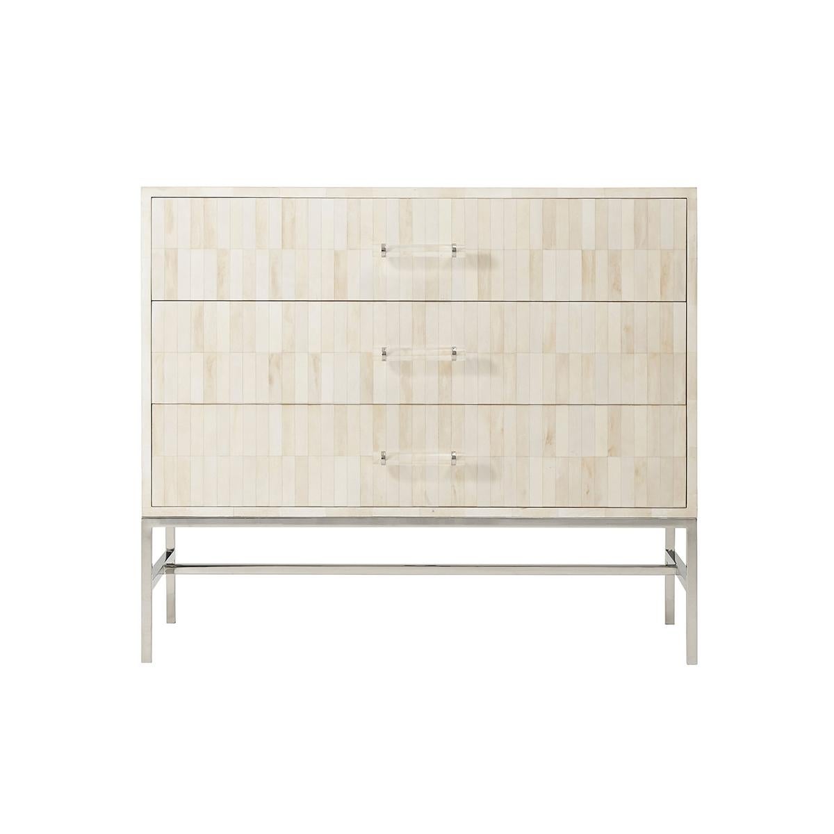 With hand-painted faux bone drawer fronts and upper case, the three soft closing drawers each with modern stainless steel and acrylic handles. Raised on a stainless steel H form stretcher base.
Dimensions: 42