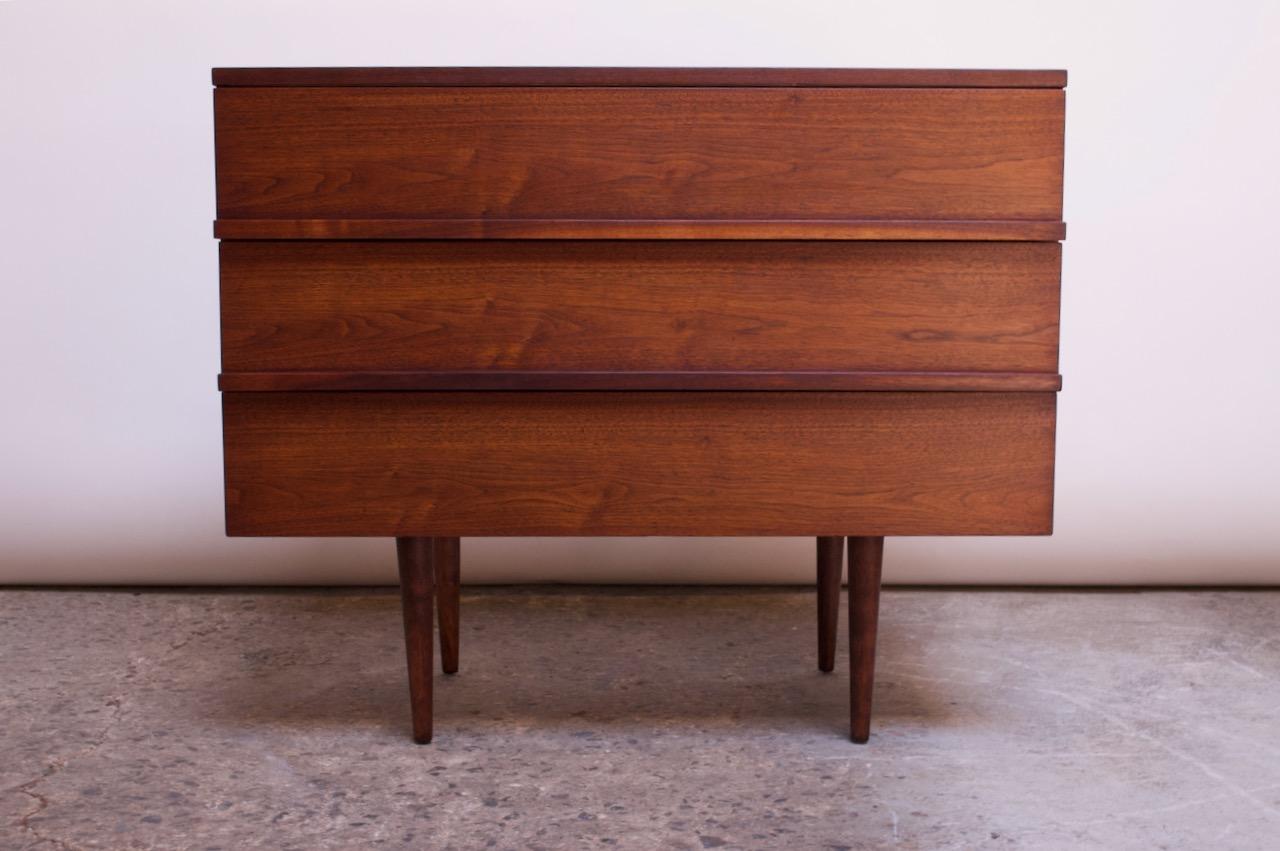 Mel Smilow walnut chest designed in the 1950s for Smilow-Thielle. Composed of sculpted 'bar' pulls that support both the form and function of the piece, working beautifully with the minimal design and allowing the drawers to open smoothly and