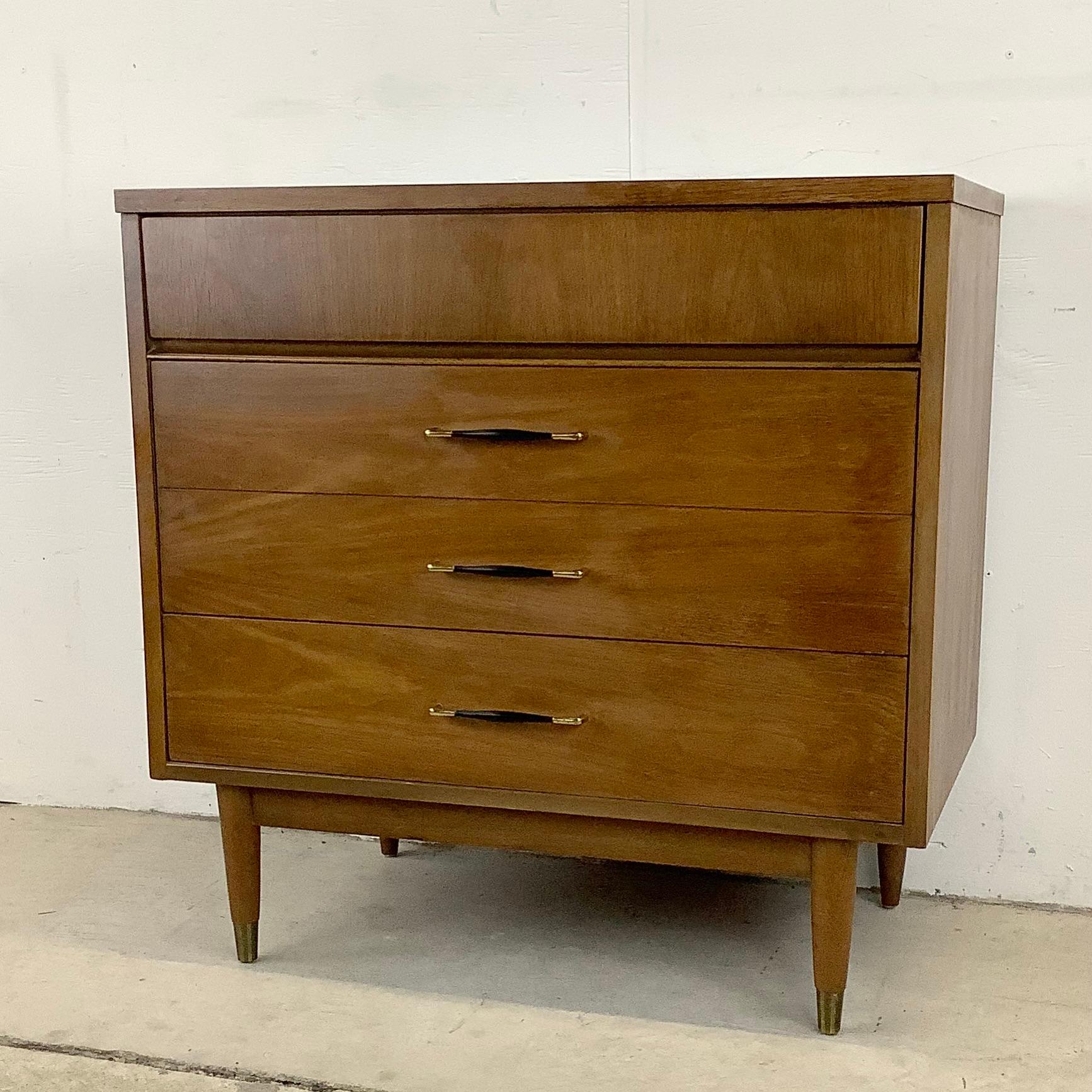 This stylish vintage modern dresser features a walnut finish and spacious three drawer configuration offering plenty of bedroom storage. The clean modern lines of the mid-century design make a striking vintage addition to any interior while the faux