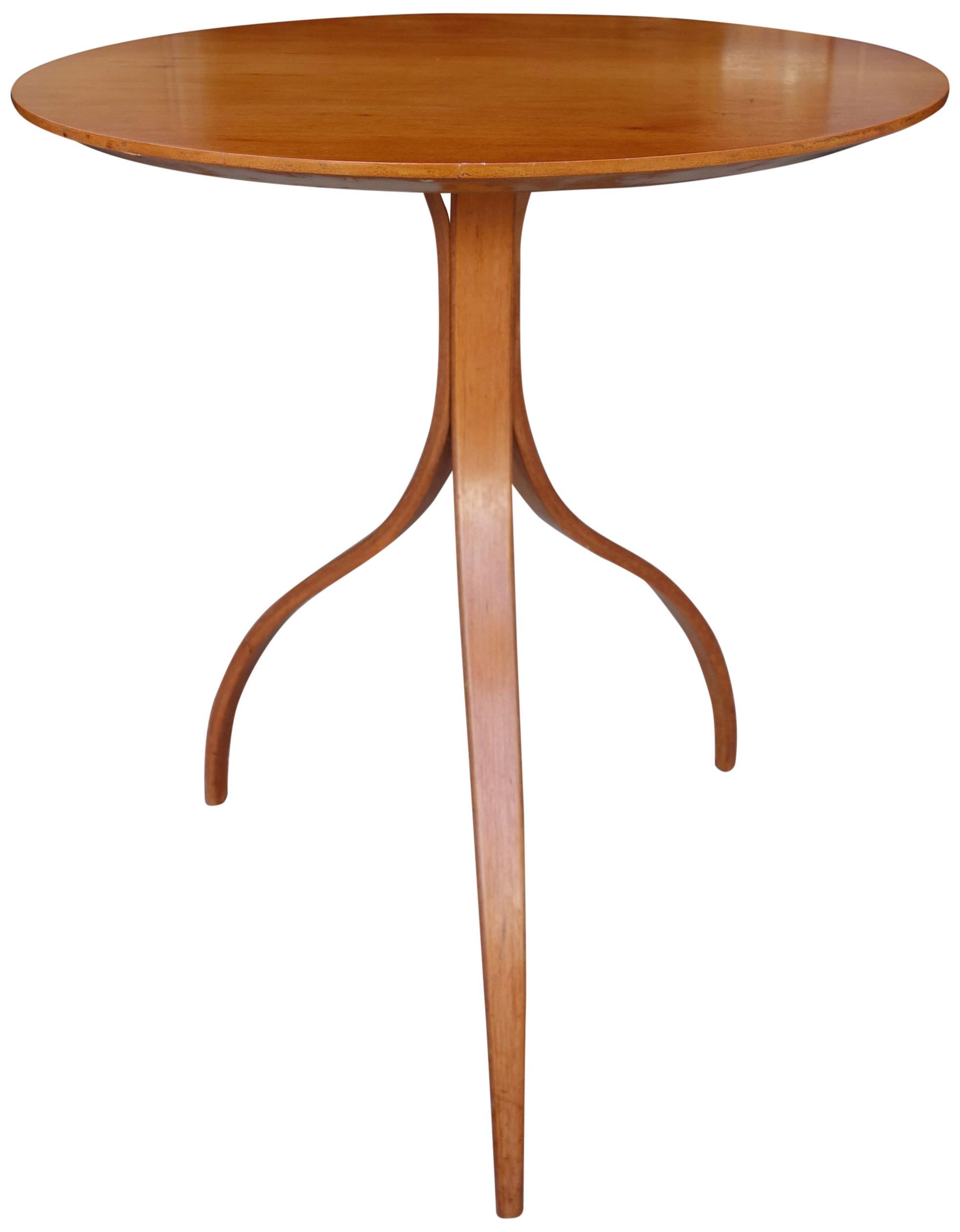 For your consideration is this beautiful and elegant three legged table in teakwood. Featuring a bentwood design and round top in original in beautiful condition with a warm patina. Reminiscent of Dunbar Wormley designs.

The top is 20 inches wide