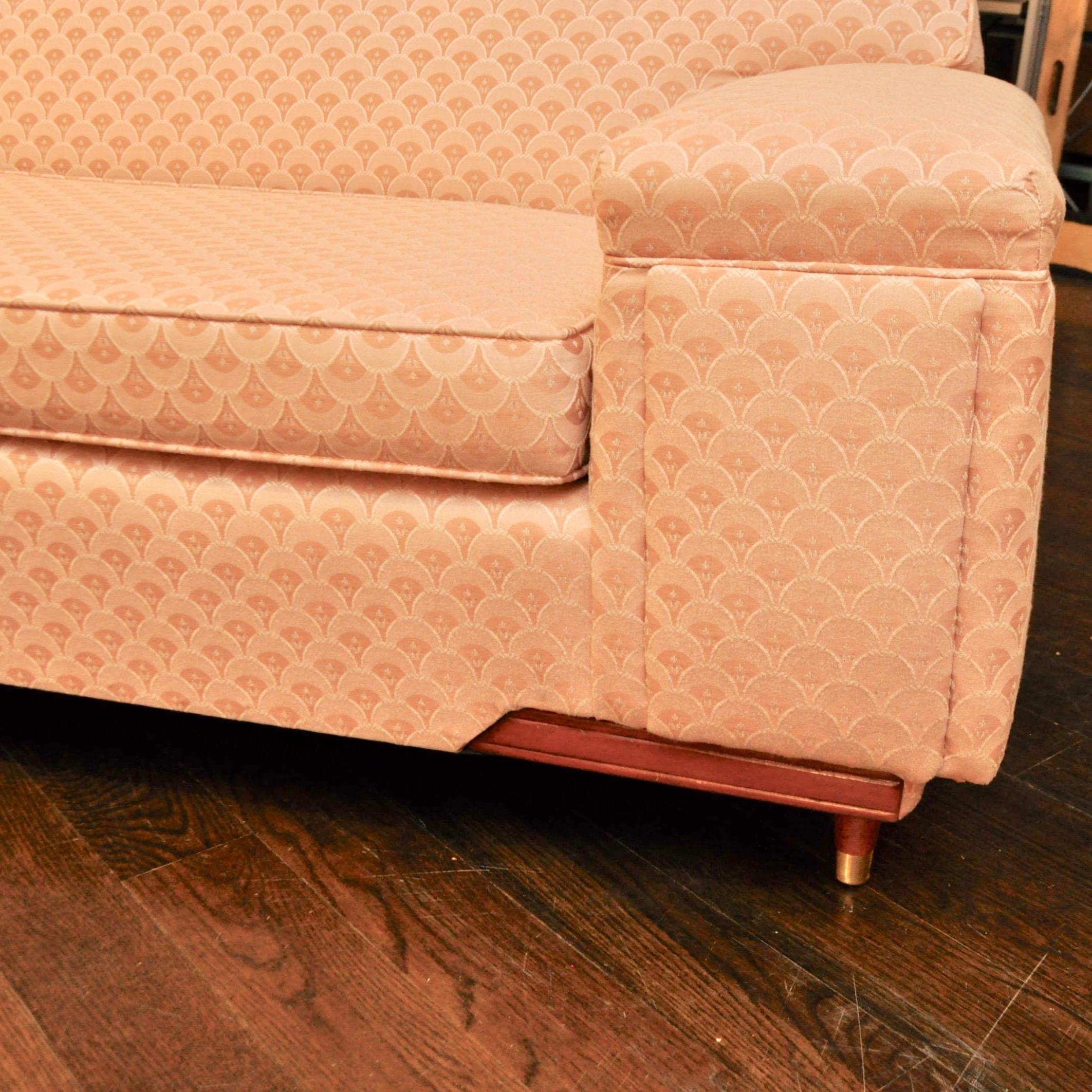This sectional must have been wrapped in clear vinyl most of its life because its vintage upholstery is in like new condition. Even the original peachy pink arm covers are present. If you're looking for an iconic fifties-shaped sectional, this would