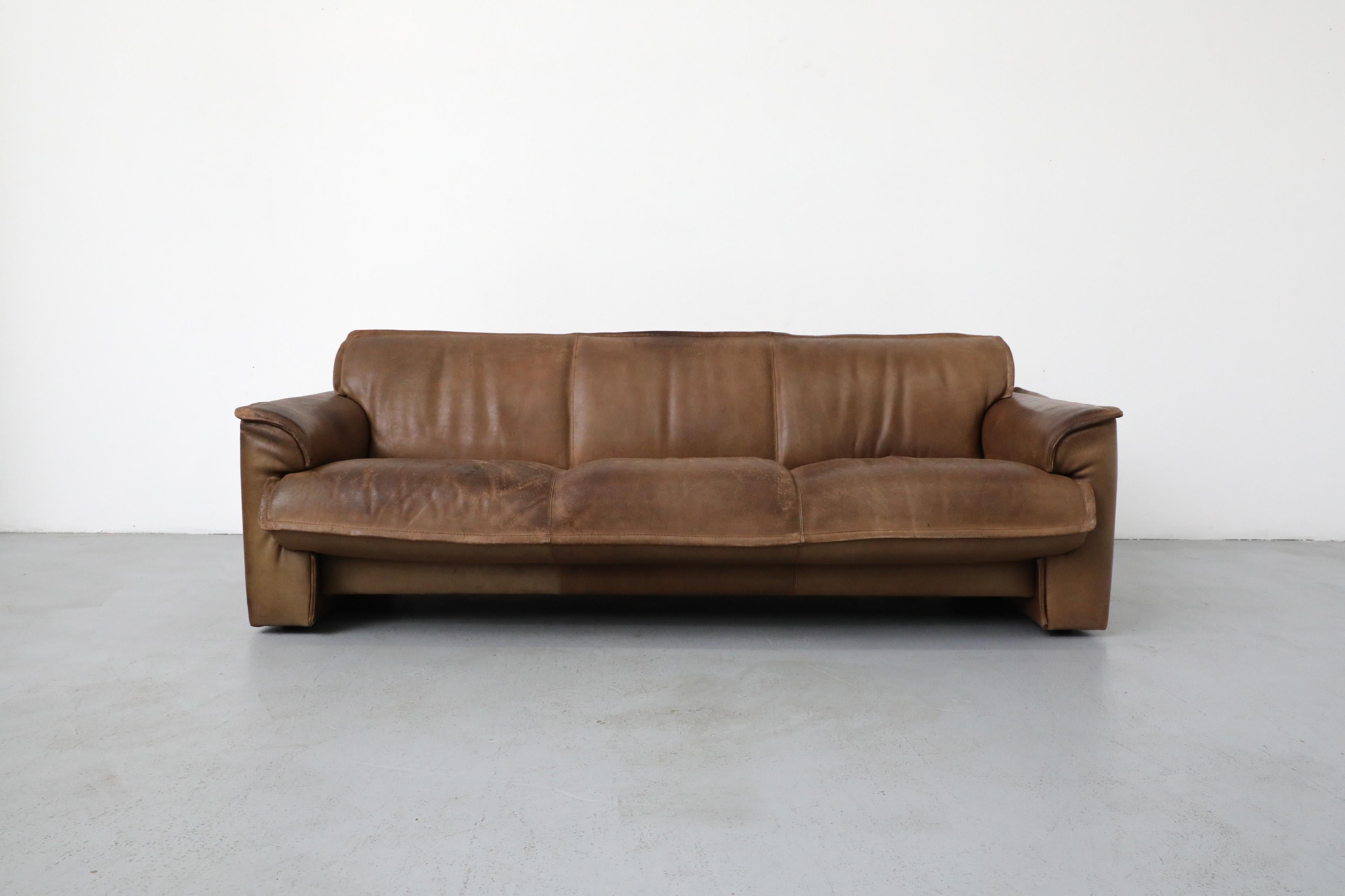 Mid-Century LeoLux three seater sofa made with thick buffalo leather. This sturdy sofa is in original condition with heavy patina and wear that is consistent with it's age and use. 