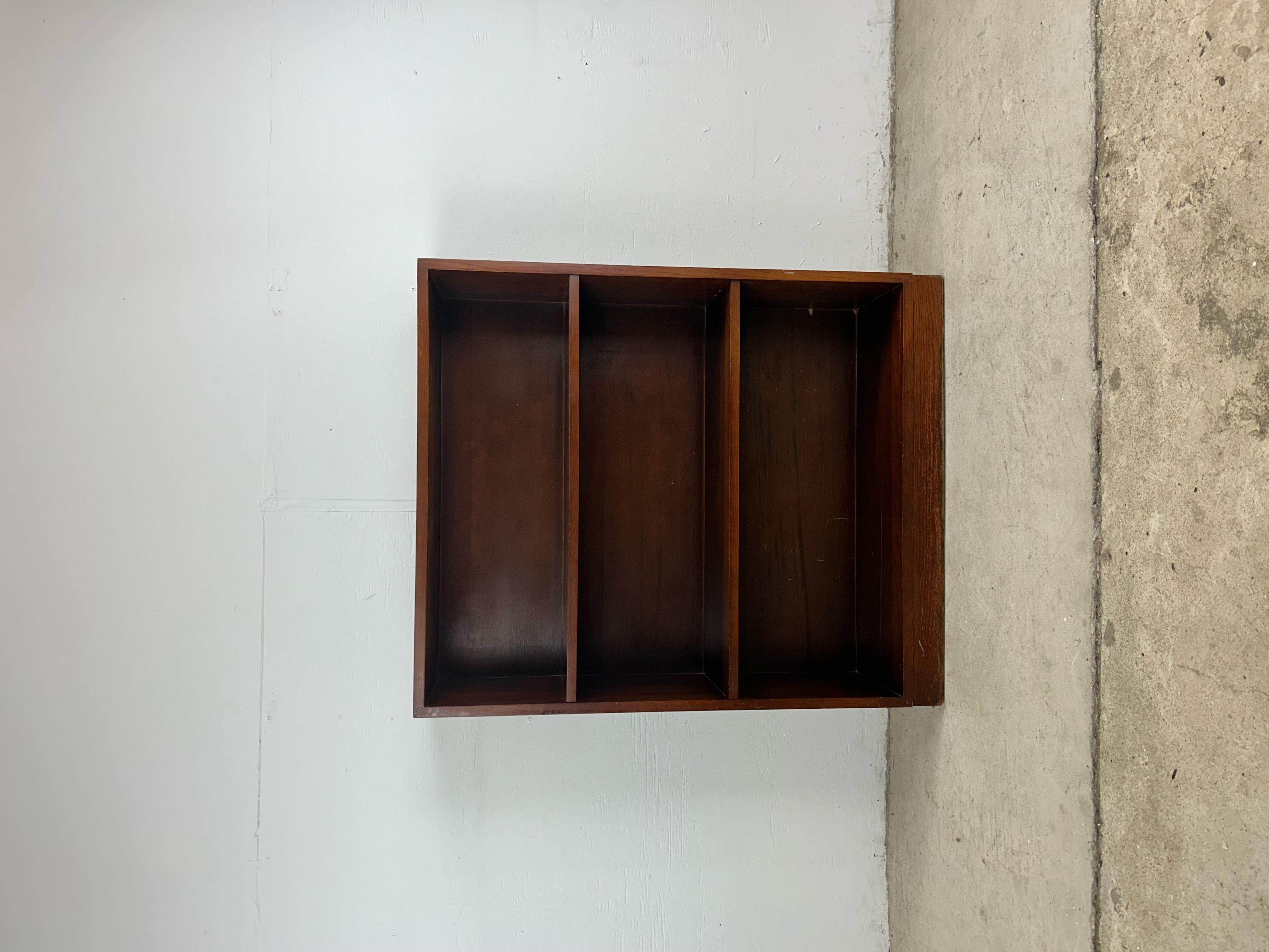 This mid century modern bookcase features hardwood oak construction, original dark walnut finish, and a three shelf design offering ample media storage or display space.
 Dimensions: 30w 9.5d 36h

Condition: Original finish has minor scuffs,