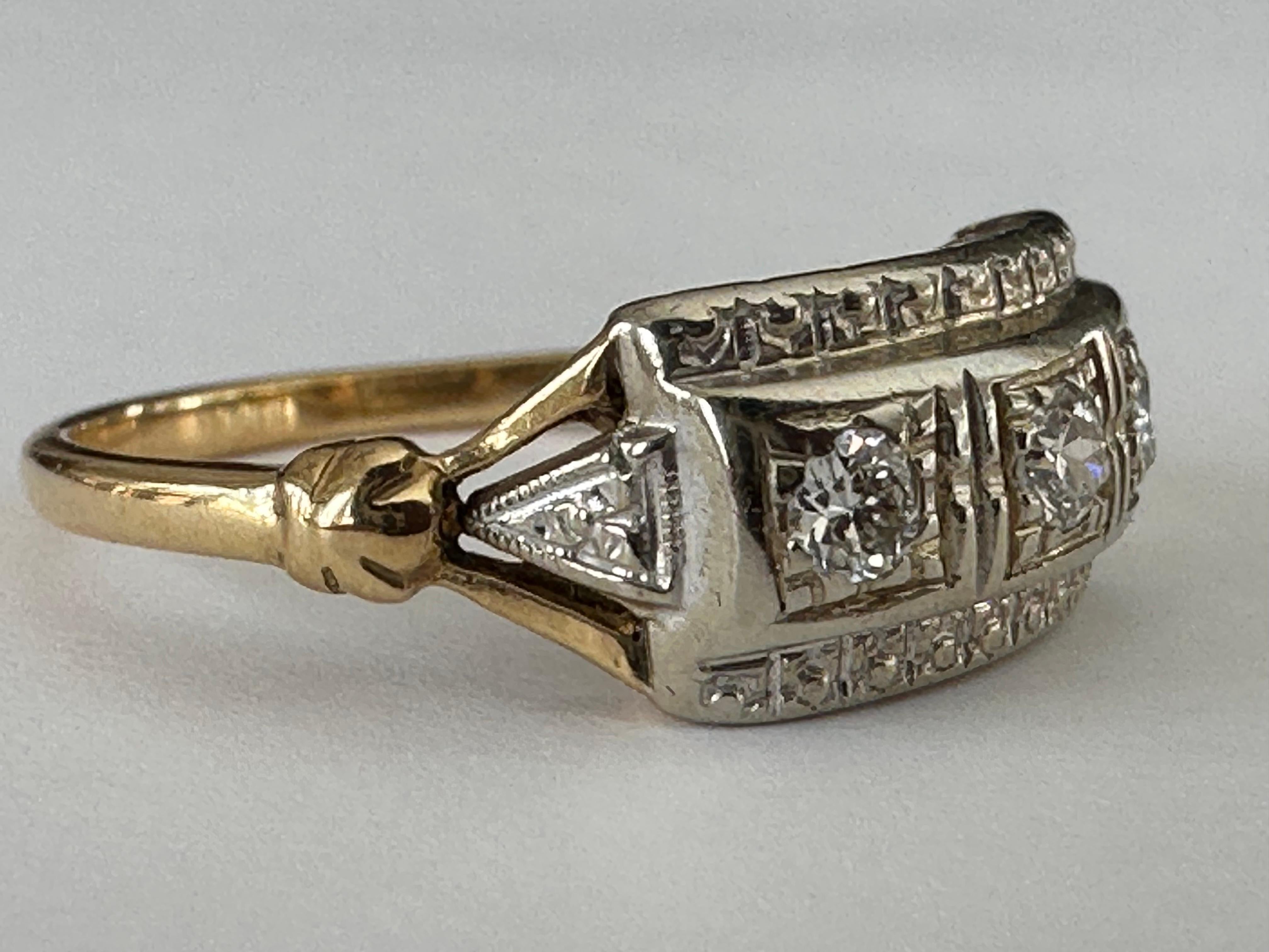 Crafted in the 1950s from 14kt yellow and white gold, this stunning Mid-Century two tone band is designed around three Old European cut diamonds totaling approximately 0.18 carats, H color, VS clarity with an East-West orientation. 