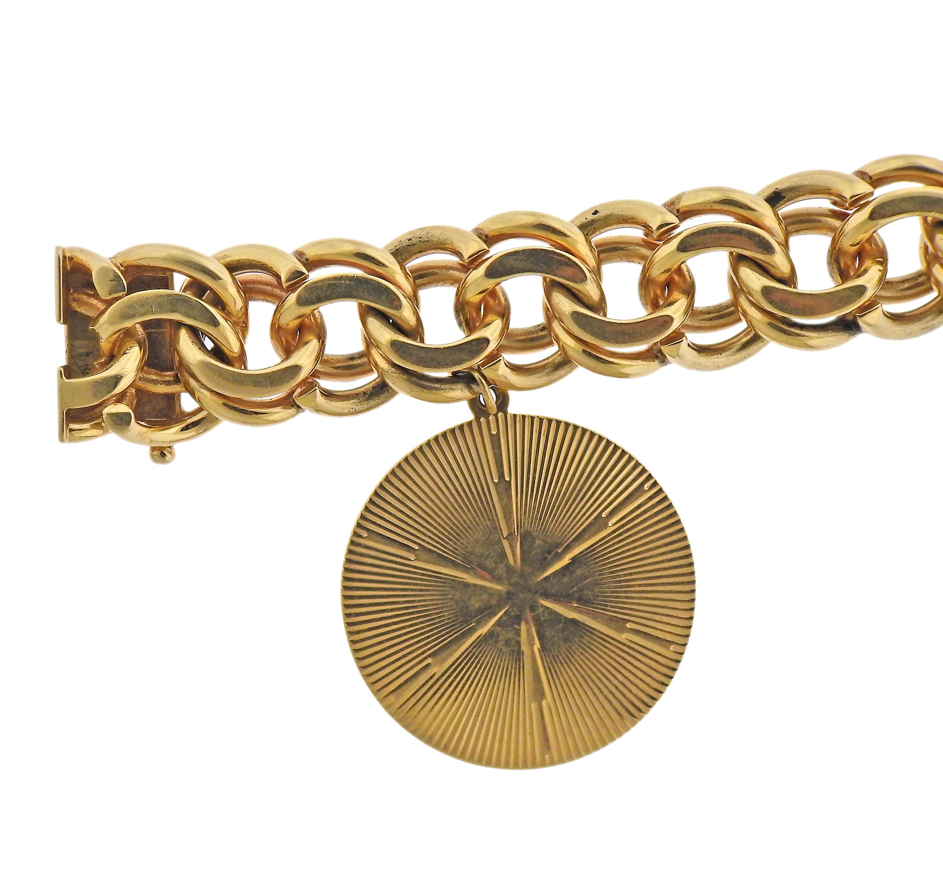 Chunky and substantial 14k gold Mid century bracelet by Tiffany & Co, with a T & Co 4k gold medallion charm. Both pieces marked Tiffany & Co, 14k. Medallion engraved 