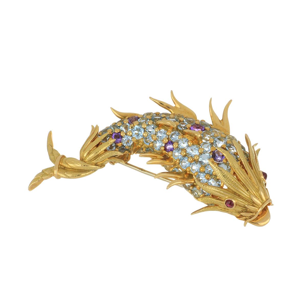Important Mid-Century Tiffany & Co. Schlumberger 18K yellow gold gemstone fish pin.  Circa 1965.  There are 5.75 carats of aquamarines, 0.45 carats of amethysts, and 0.15 carats of rubies.
*Important due to the Time Period and Iconic Nature of the
