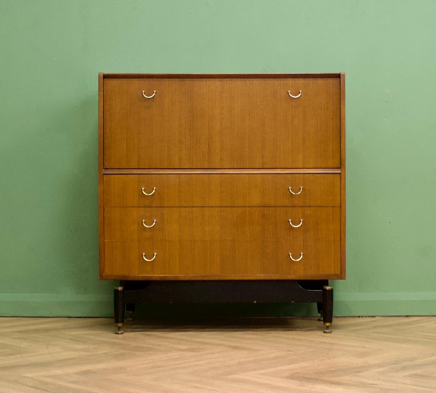 A mid century Tola and Black tallboy chest from G Plan (E Gomme)
Featuring a pull down compartment with an internal shelf and three drawers