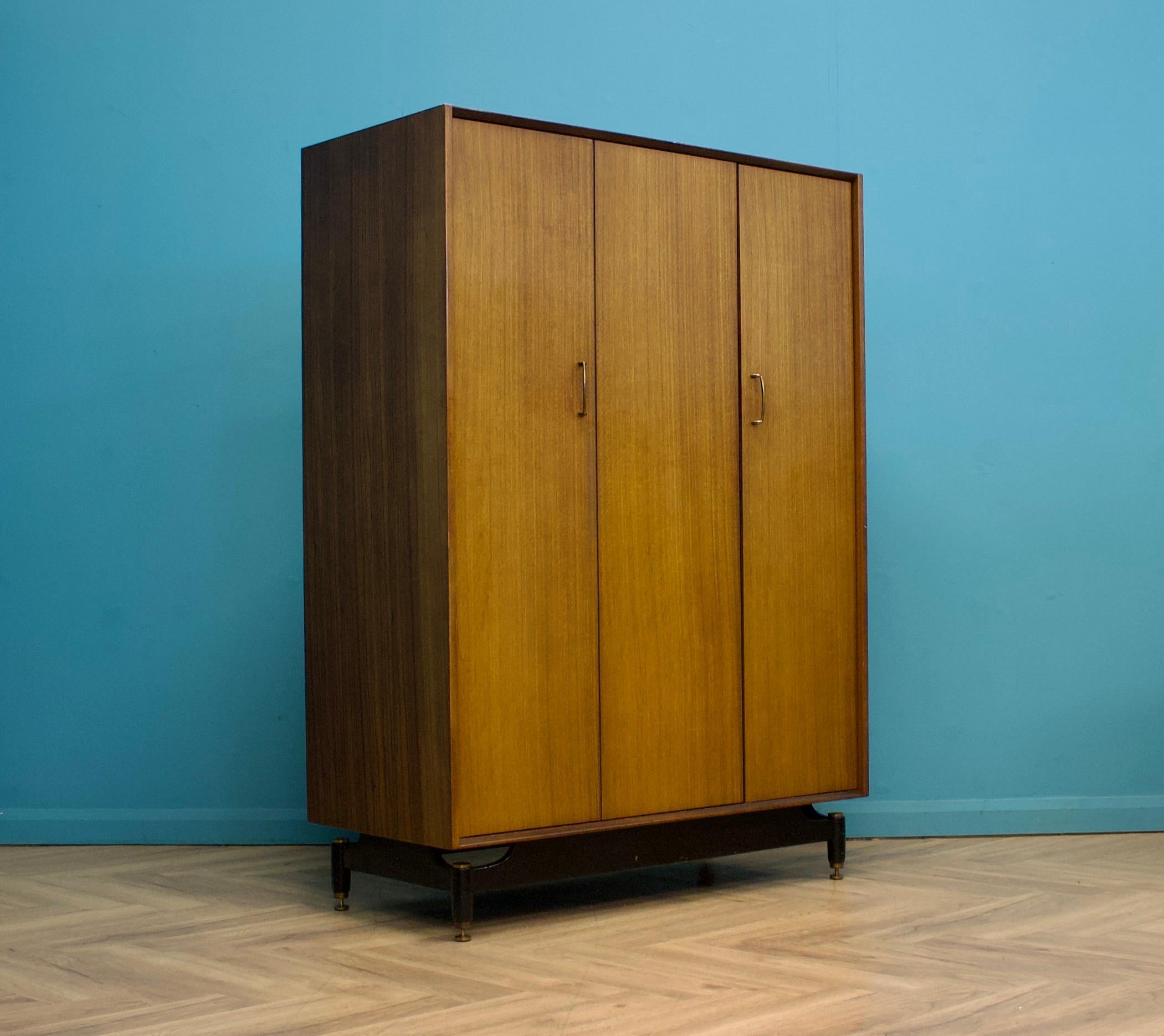 A mid century three door Tola and Black wardrobe from G Plan (EGomme)
Featuring a bi fold door and a rail the full width


This wardrobe dismantles
