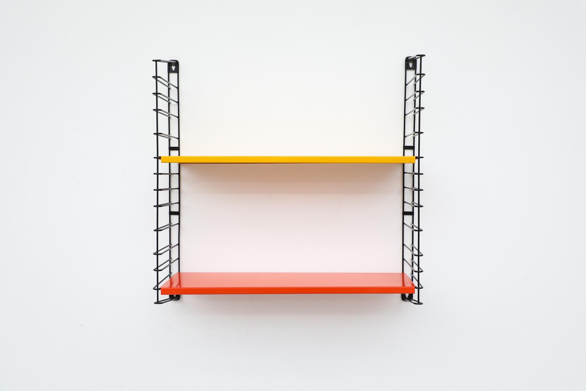 Midcentury TOMADO industrial shelving with newly powder coated yellow and orange shelves on black enameled metal wire risers. Designed by Jan van der Togt. Both shelves rest on the wire risers and can be arranged to different heights. Others