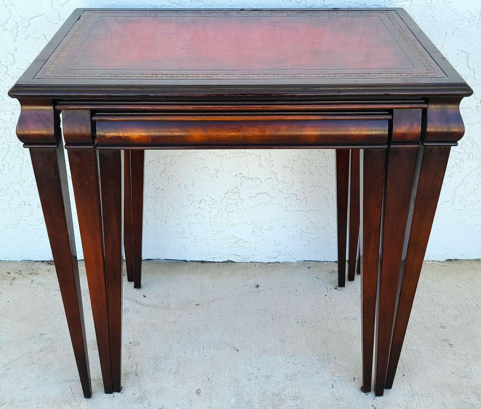 Offering one of our recent palm beach estate fine furniture acquisitions of a
Set of 3 mid century 1950s tooled red leather mahogany nesting tables 
They are interlocking so when they are together, you only have to lift the large on to move them