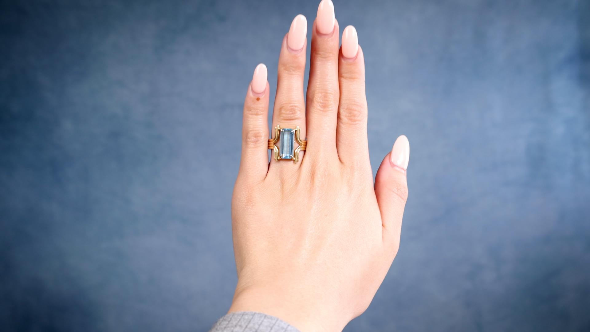 One Mid-Century Topaz 14k Yellow Gold Ring. Featuring one octagonal step cut sky blue topaz weighing approximately 4.30 carats. Crafted in 14 karat yellow gold with purity mark. Circa 1960. The ring is a size 8 and may be resized. 

About this Item: