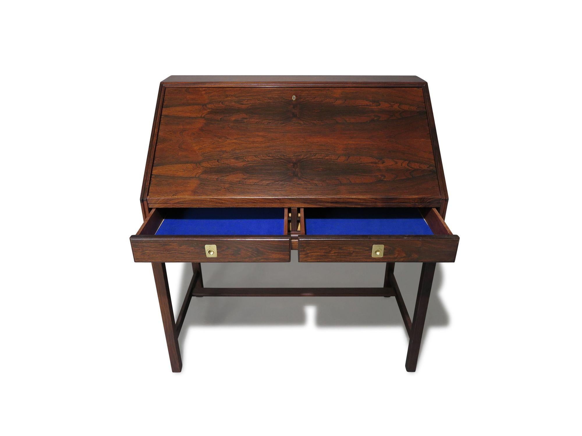 Danish secretary desk designed by Torbjørn Afdal for Nesjestranda Møbelfabrik, Norway, 1965. Crafted from Brazilian rosewood, the secretary desk features a locking drop-front desk that opens to reveal a rosewood interior with a series of small