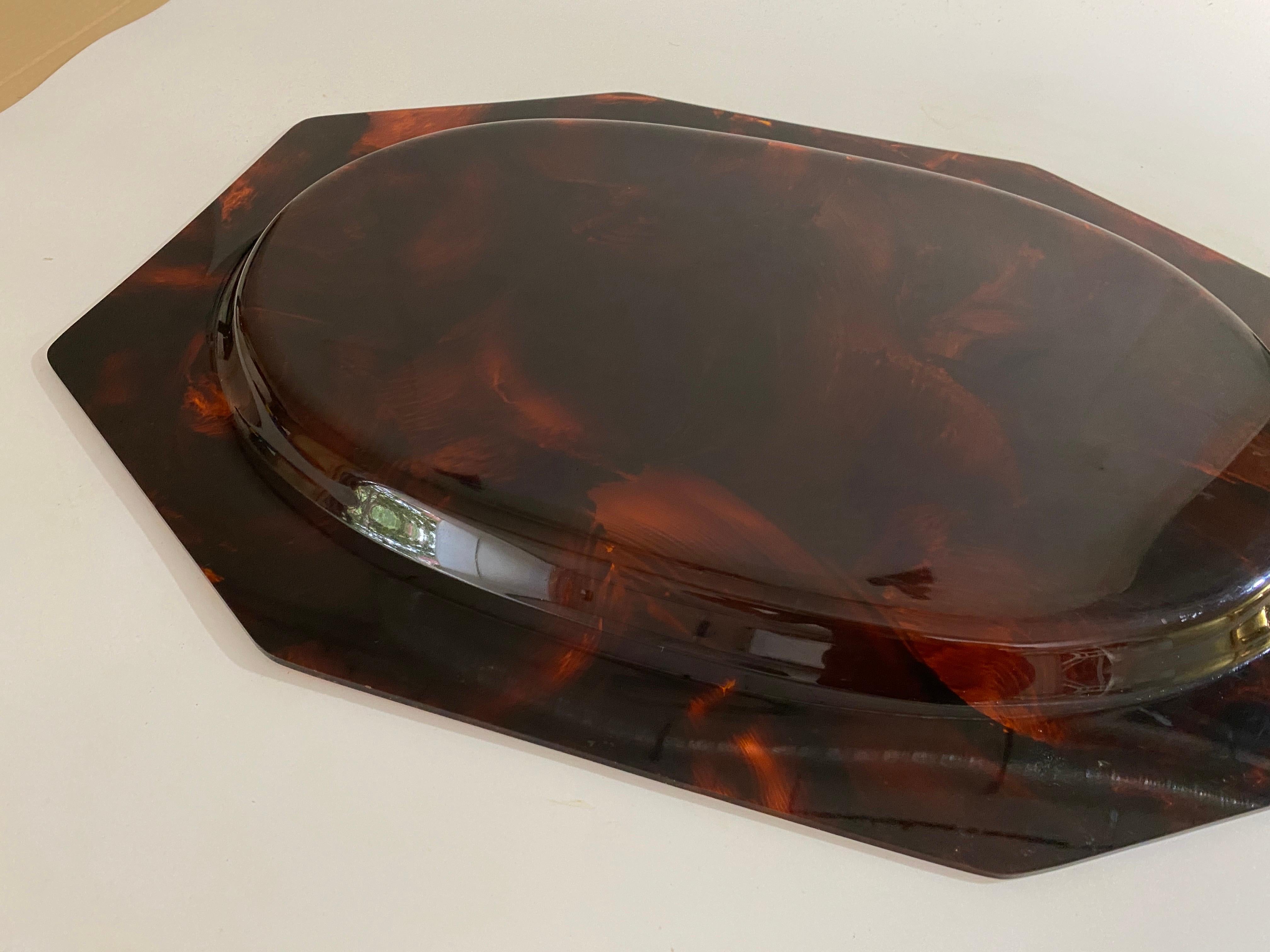 Faux tortoiseshell tray, attributed to Christian Dior. It was made in France in the 1970's.
Fire-colored, shimmering, resembling tortoiseshell. 
In good condition.