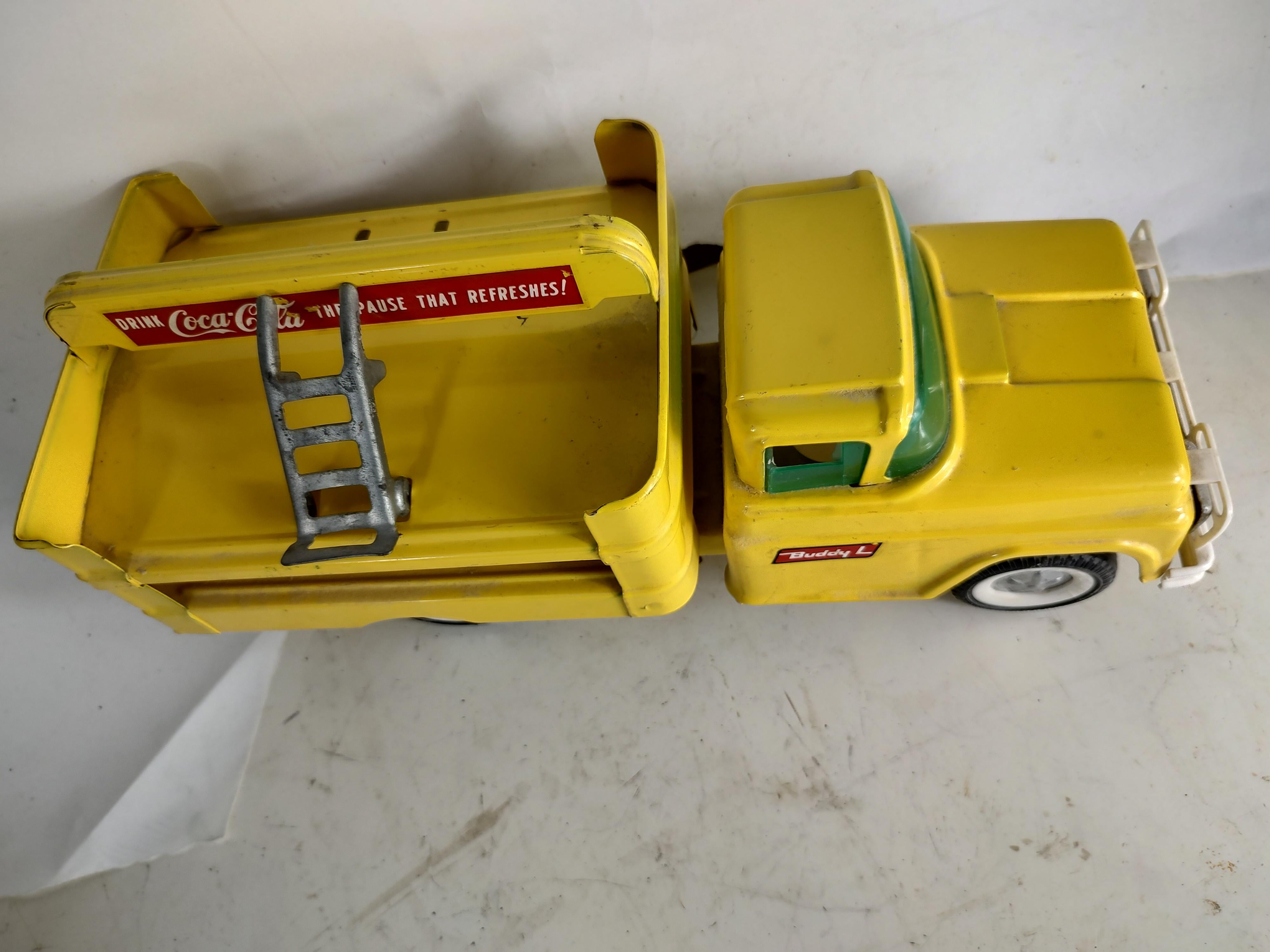 Fun coca cola truck by Buddy L from the late fifties and early sixties. In excellent used condition with minimal wear. No damage, possibly side mirror missing, has an aluminum hand truck. Front end is spring loaded and rolls along quote well.
