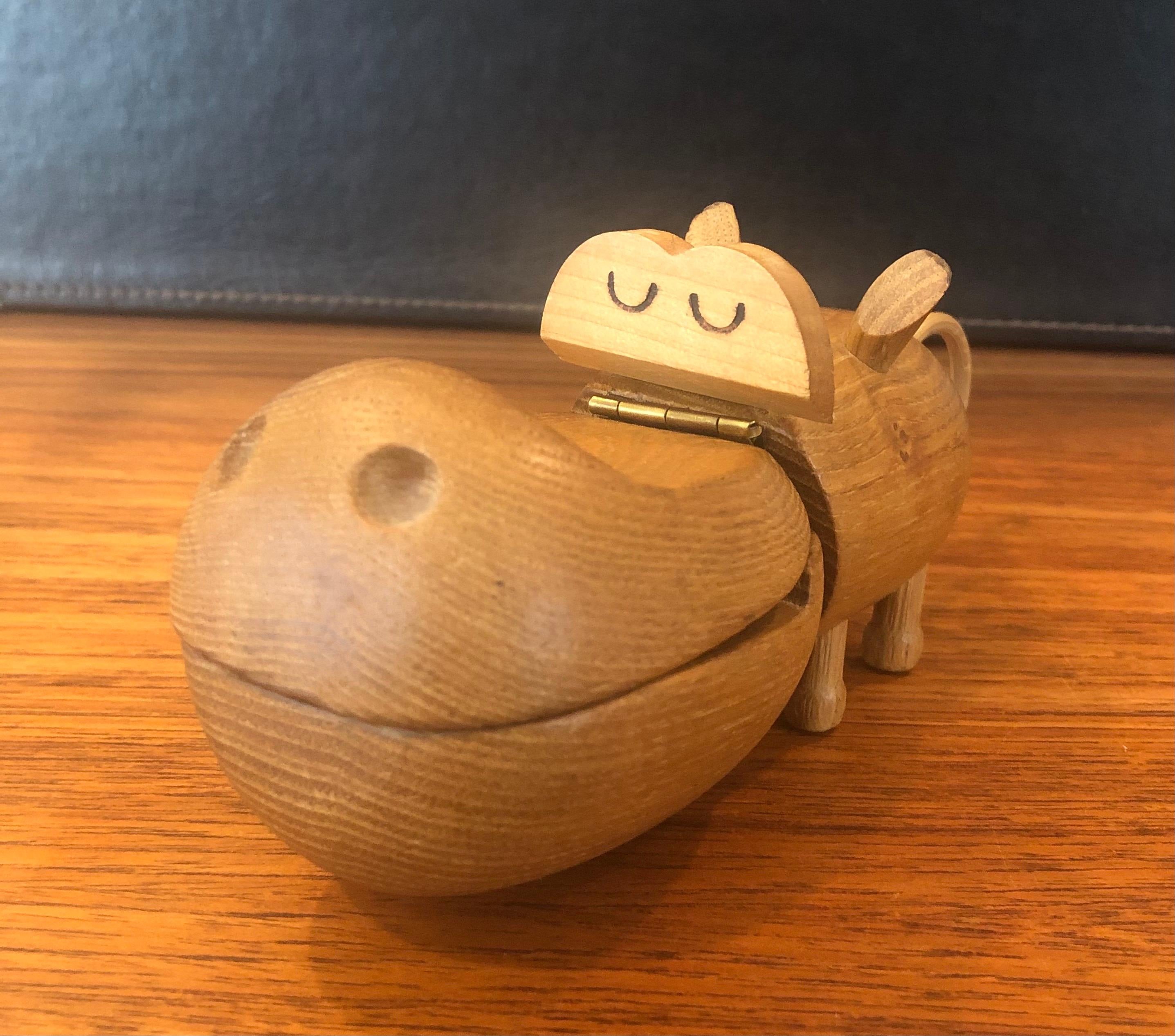 Midcentury wooden toy hippo trinket box in the style of Kay Bojesen by Zoo-Line, circa 1959. The hippo is made of oak and his mouth opens for a nice little storage area. The hippo is in good original condition and retains all parts with tail intact.