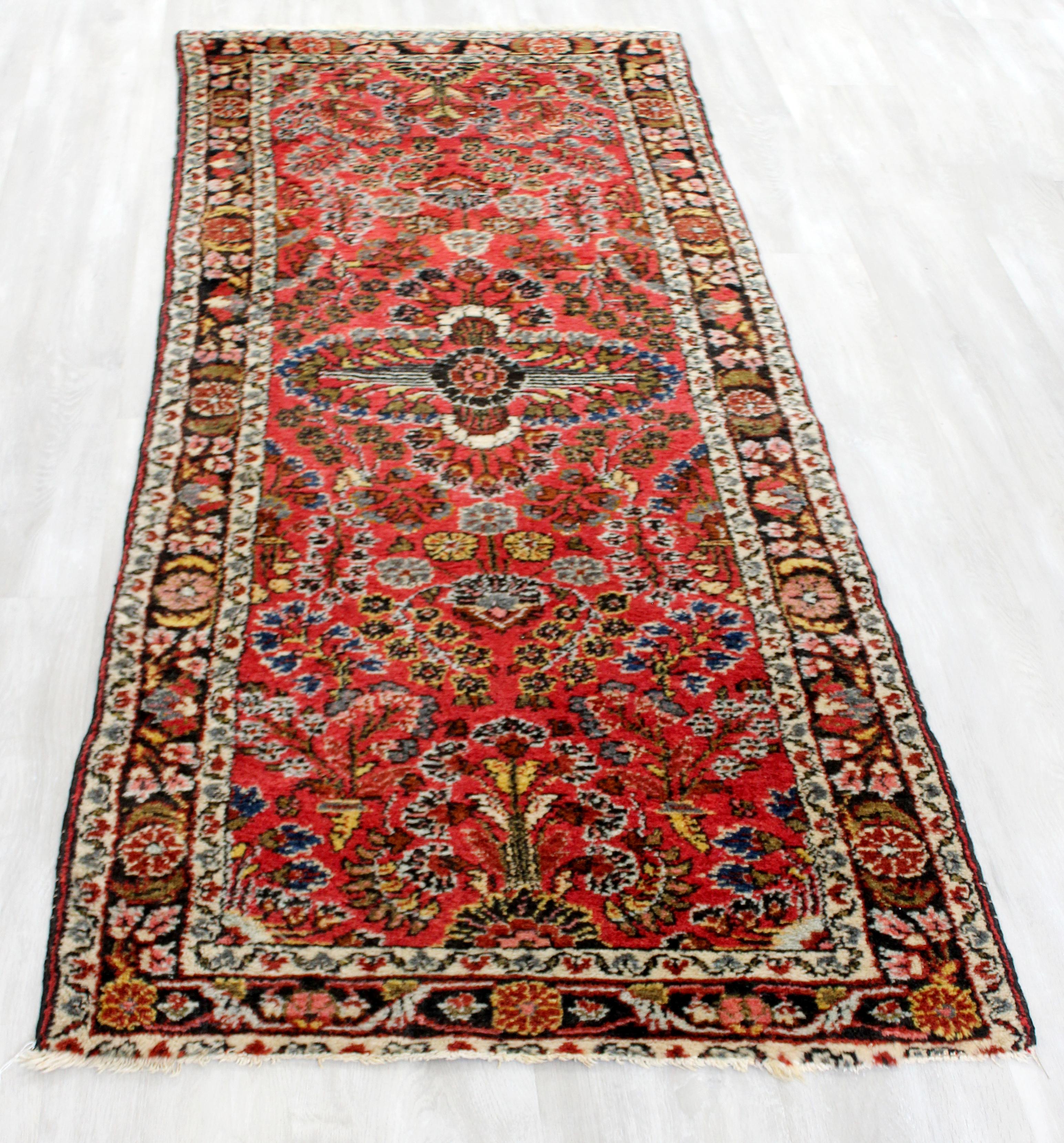 For your consideration is a beautiful and long, hand knotted wool runner rug. In good vintage condition. The dimensions are 31