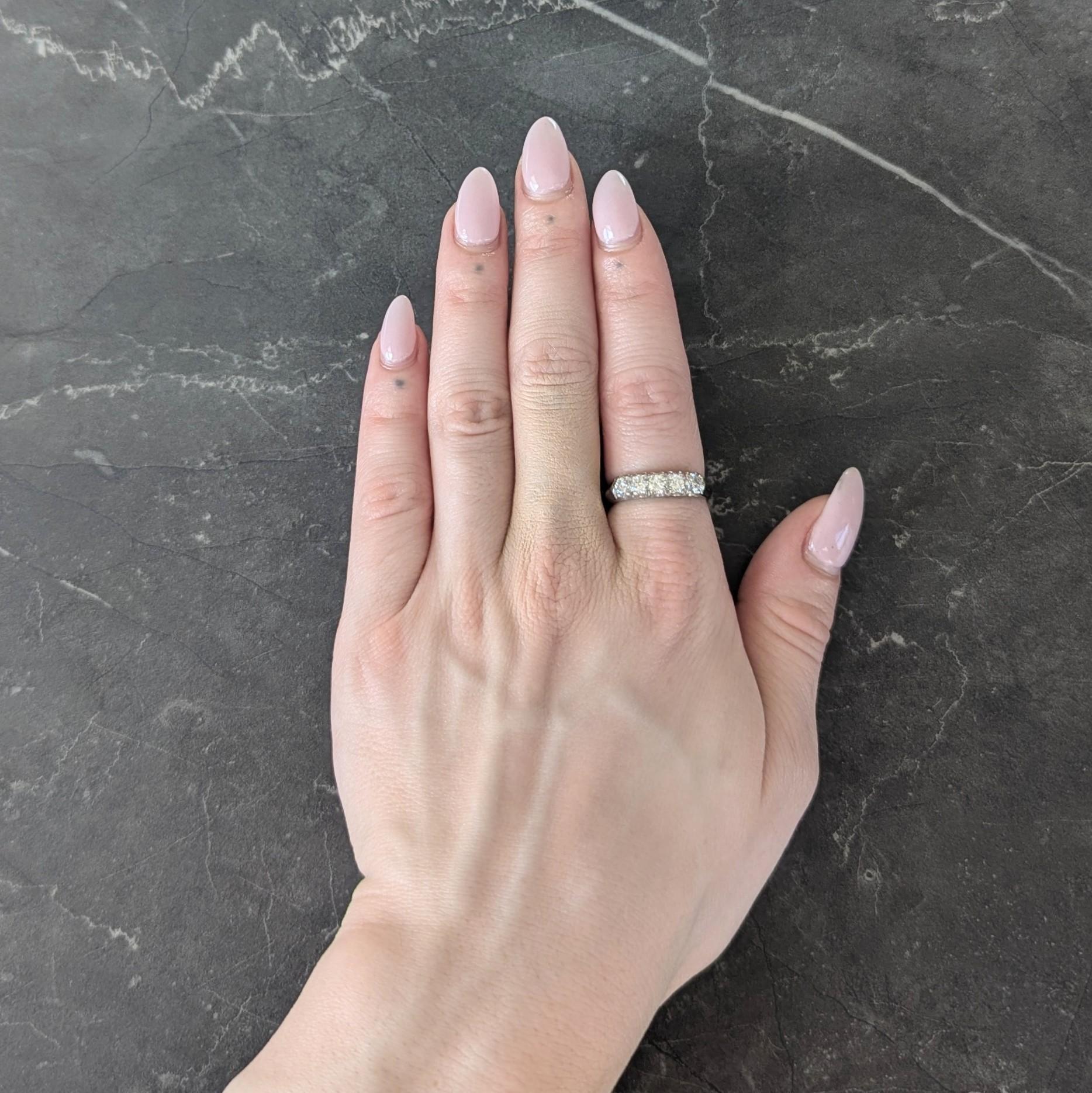 Featuring five round brilliant cut diamonds prong set in white gold east to west
Weighing approximately 0.80 carats total - H to J color with SI2 clarity
Flanked by knife edge shoulders and shank
Stamped for 14 karat gold
Circa: 1950s
Ring size: 7