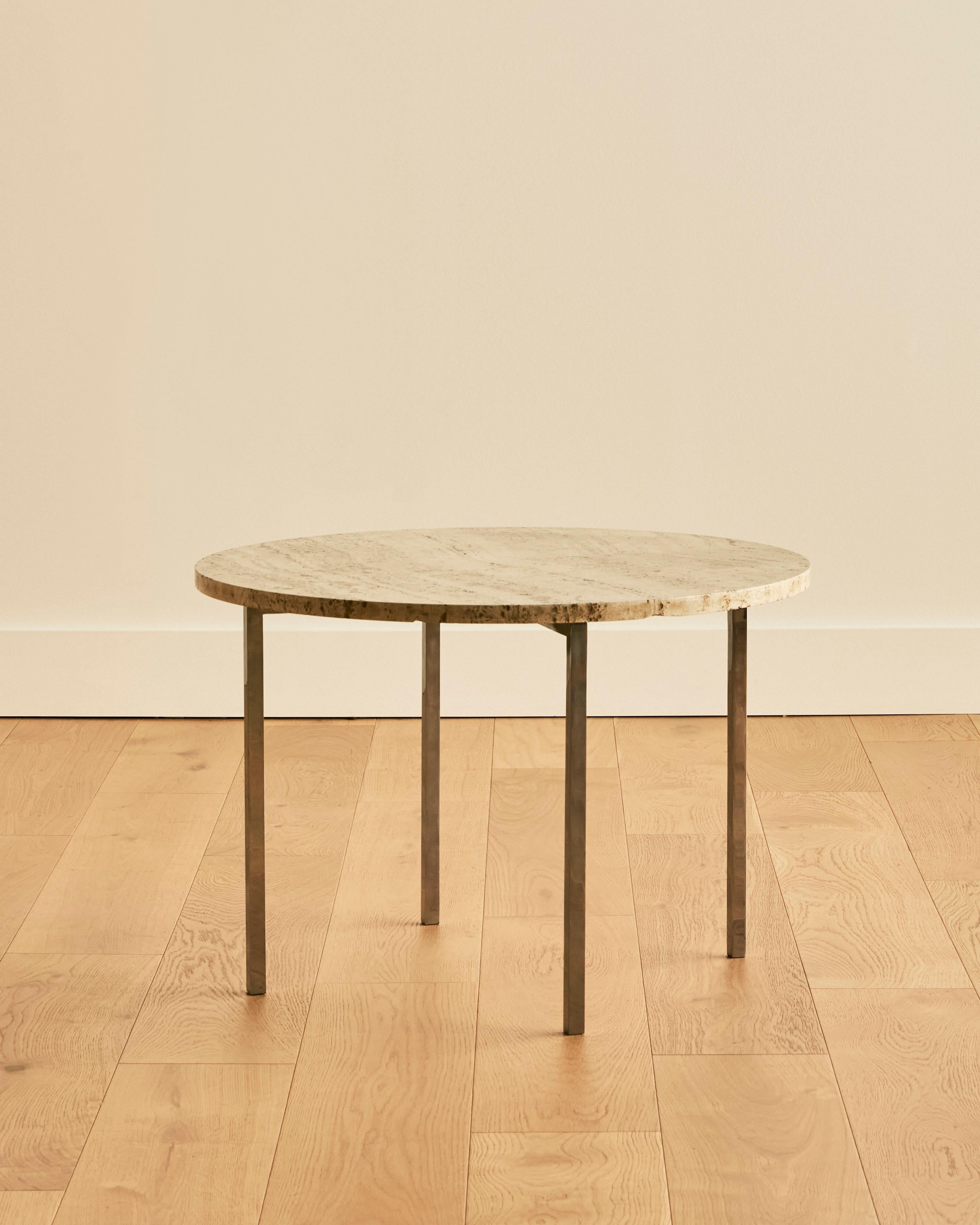 Mid century round end table with travertine top and chrome base. 