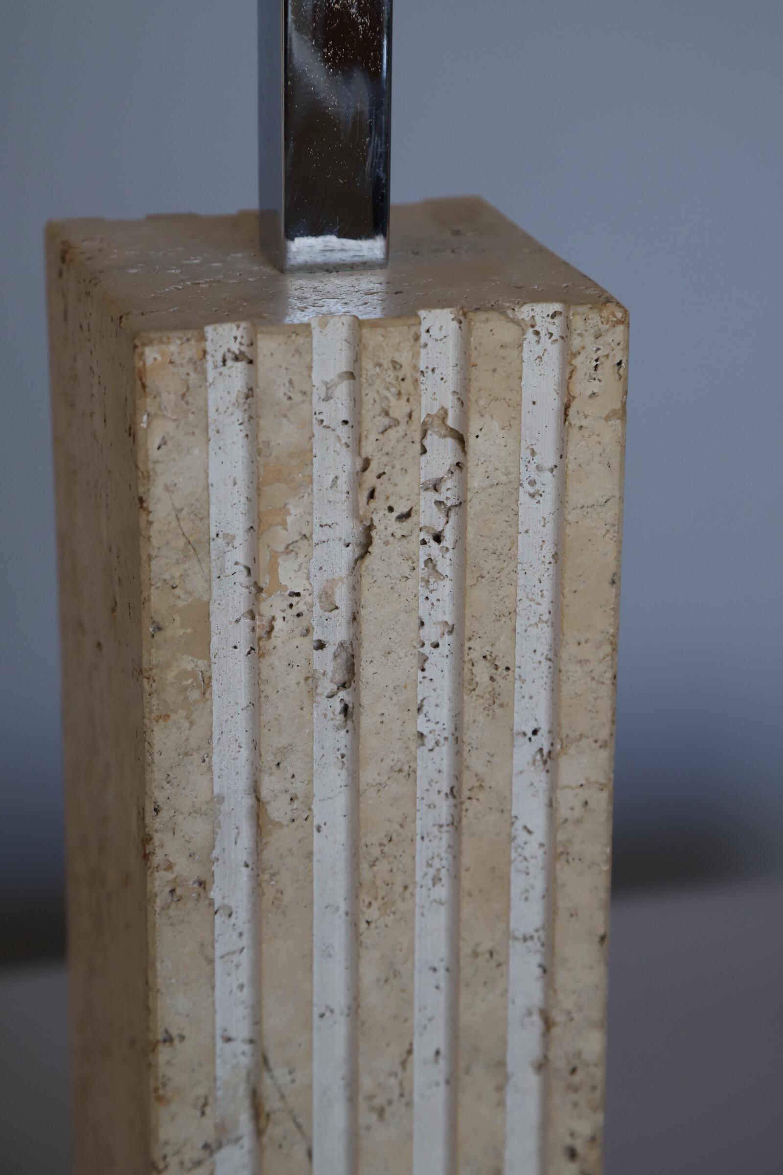 Wonderful solid travertine table lamp by Raymor of Italy. A simple and distinct look with fluting on two sides of the body.