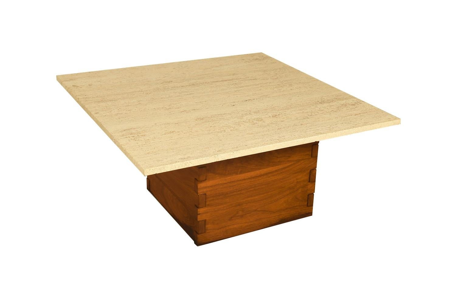 Superb Travertine and walnut Coffee Table with modernist design of remarkable quality. Features a strong walnut base accented with stylish large dovetailed joinery supporting a decorative, heavy, thick, travertine stone top. A striking design, the