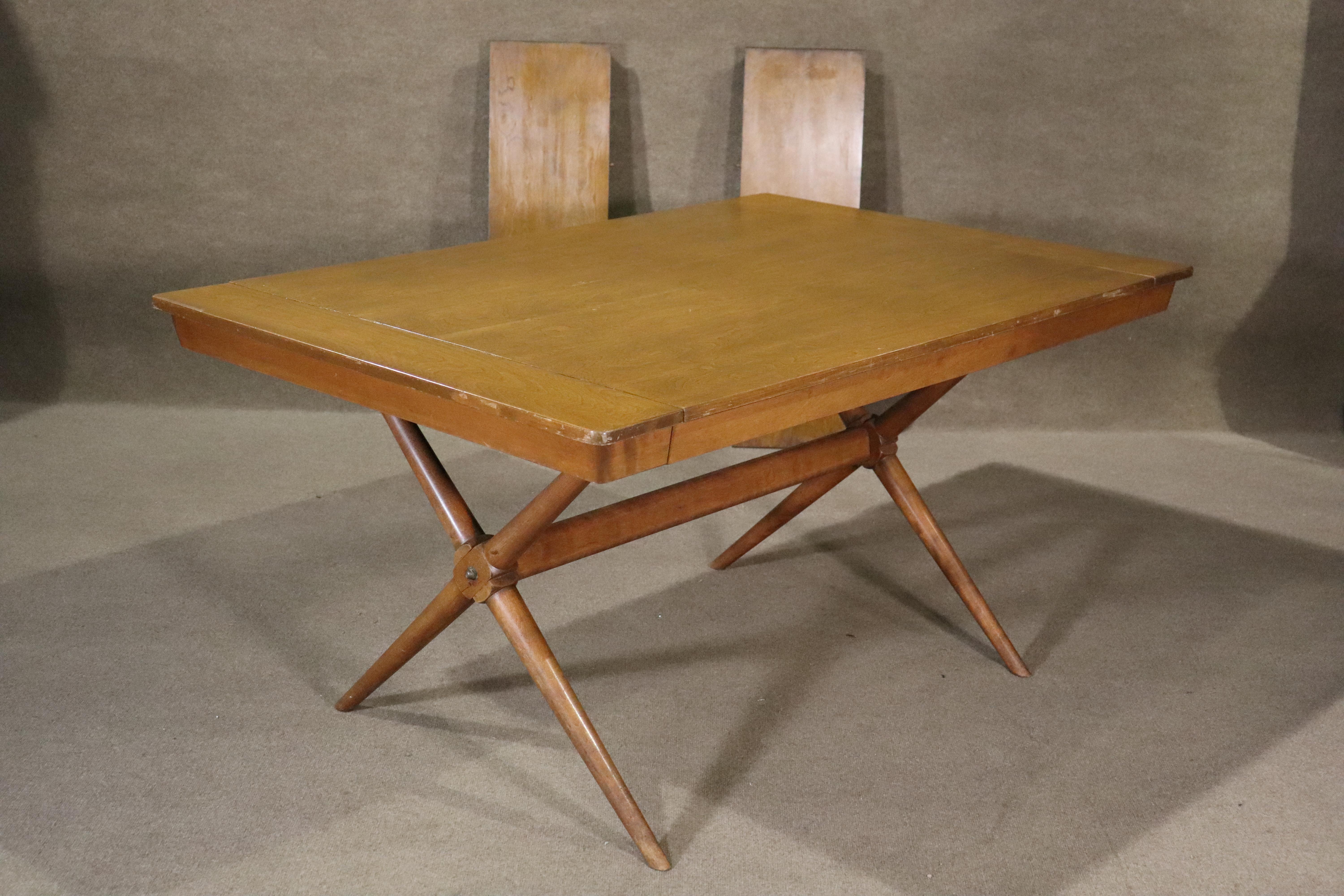 Mid-century modern dining table with 'X' style trestle base. Simple and handsome design with two 12