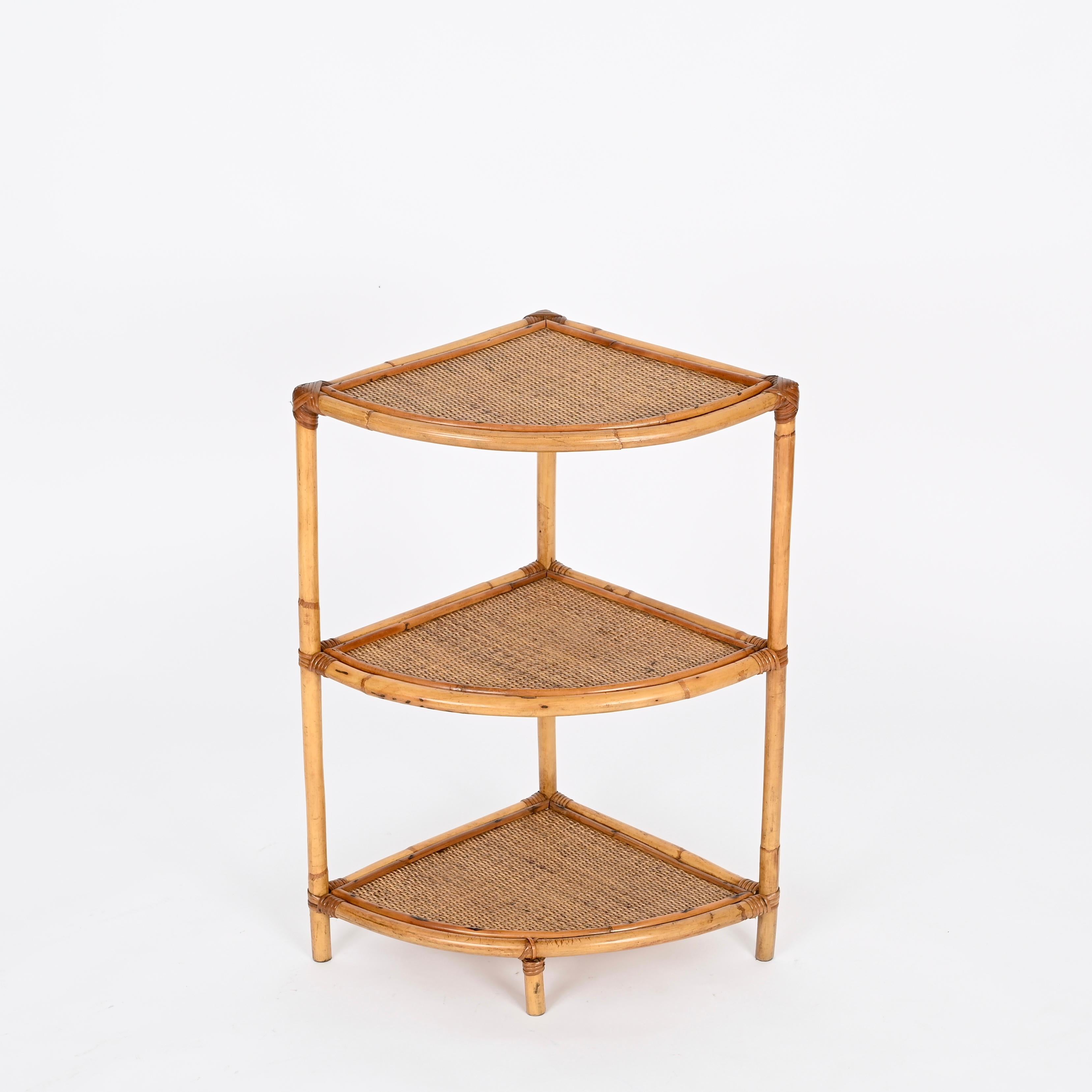 Wonderful French Riviera style triangular corner bookshelf made in bamboo, hand.woven rattan and wicker. This lovely organic bookshelf was hand-made in Italy during the 1970s. 

In fantastic condition and with a charming honey color. This delightful