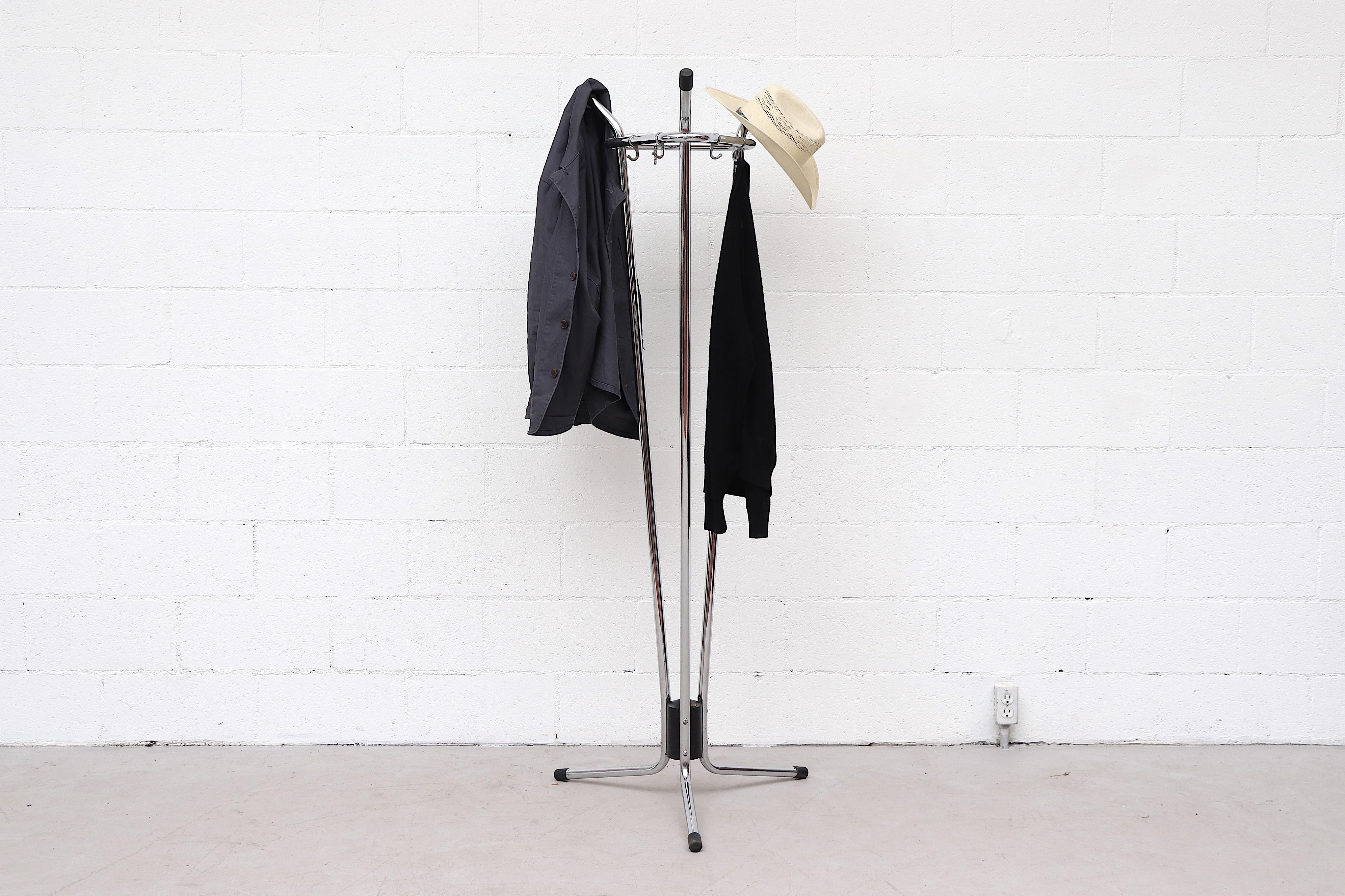 Impressive Tubax (attributed) industrial coat rack with three chrome tube arms creating a triangular freestanding coat rack with 6 hooks and center weight. In original condition with minimal wear and black rubber foot caps.