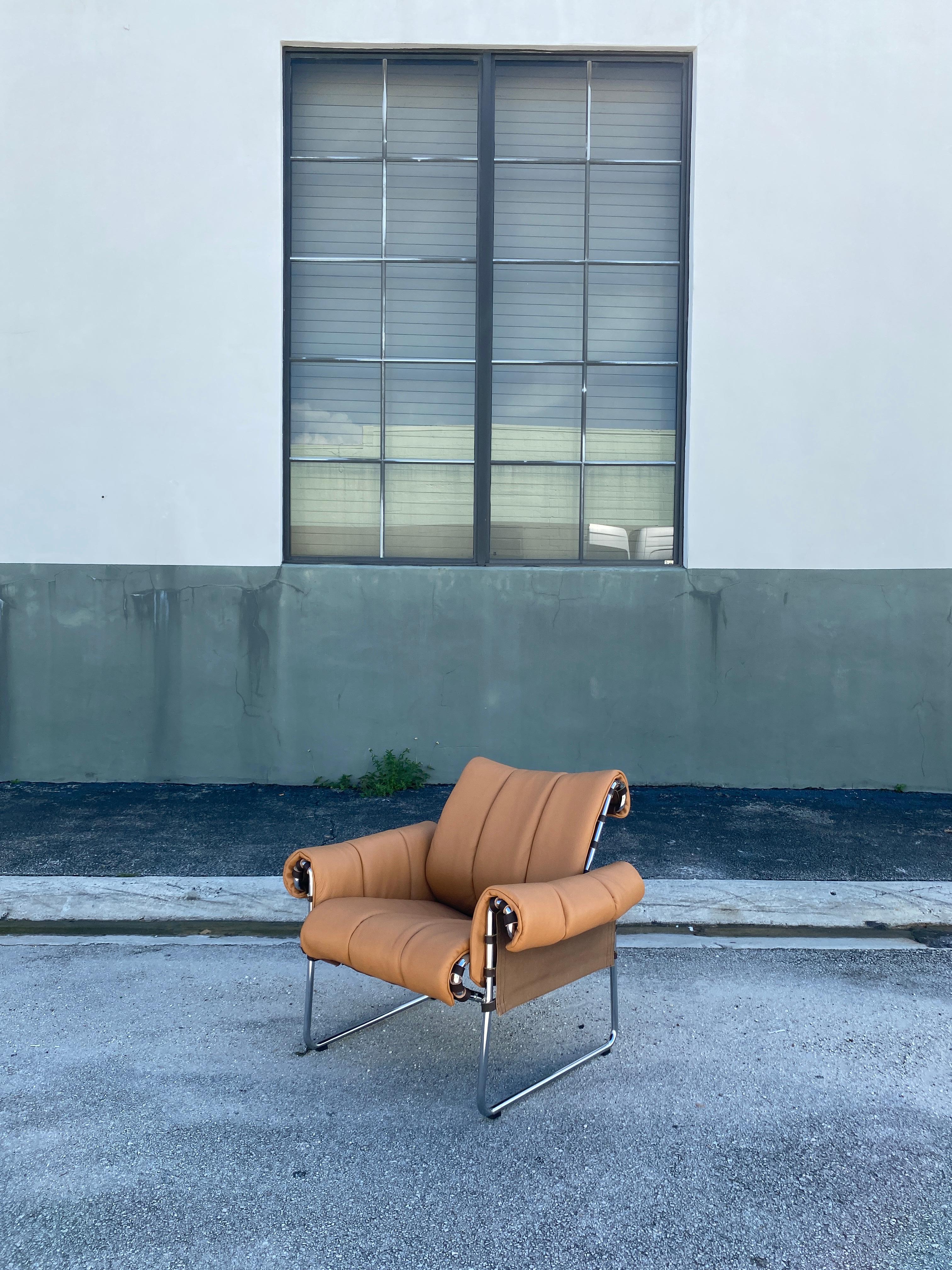 Unique tubular chair design with leather straps and canvas sling supporting the recently upholstered soft ‘gaucho’ leather. Circa 1970s.

Measures: 32” W x 27” D x 29” H x 15.5” Seat H x 21.5” Arm H.