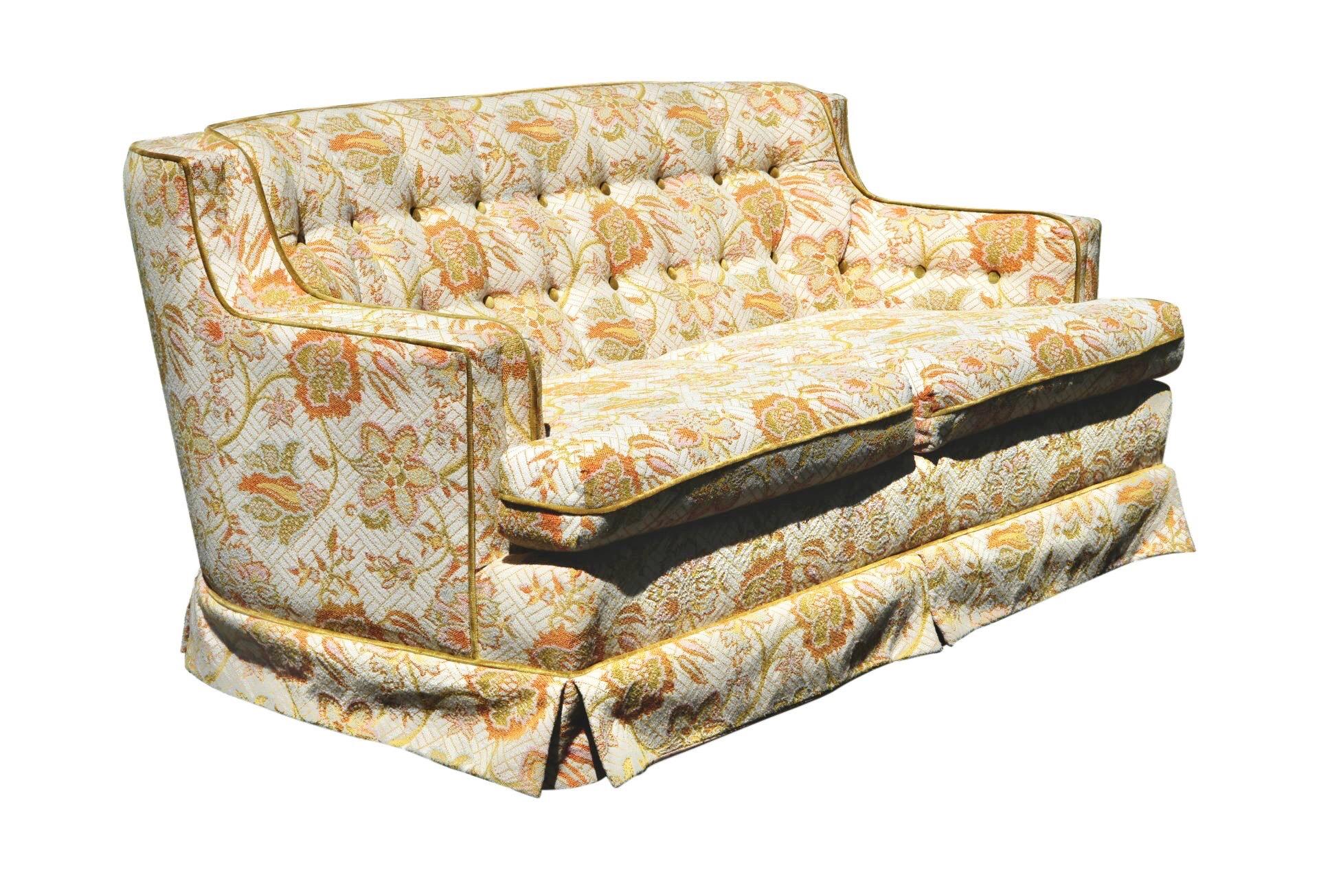 A mid century tufted floral loveseat sofa made by Style House Custom Furniture for Montgomery Ward, dated 1967. The sofa has a low profile with curved corners that meet flat arms. Upholstered throughout in a bold jacquard fabric decorated with