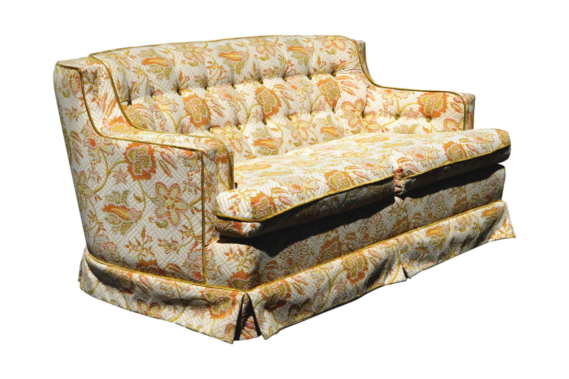 A mid-century tufted floral loveseat sofa made by Style House Custom Furniture for Montgomery Ward, dated 1967. The sofa has a low profile with curved corners that meet flat arms. Upholstered throughout in a bold jacquard fabric decorated with