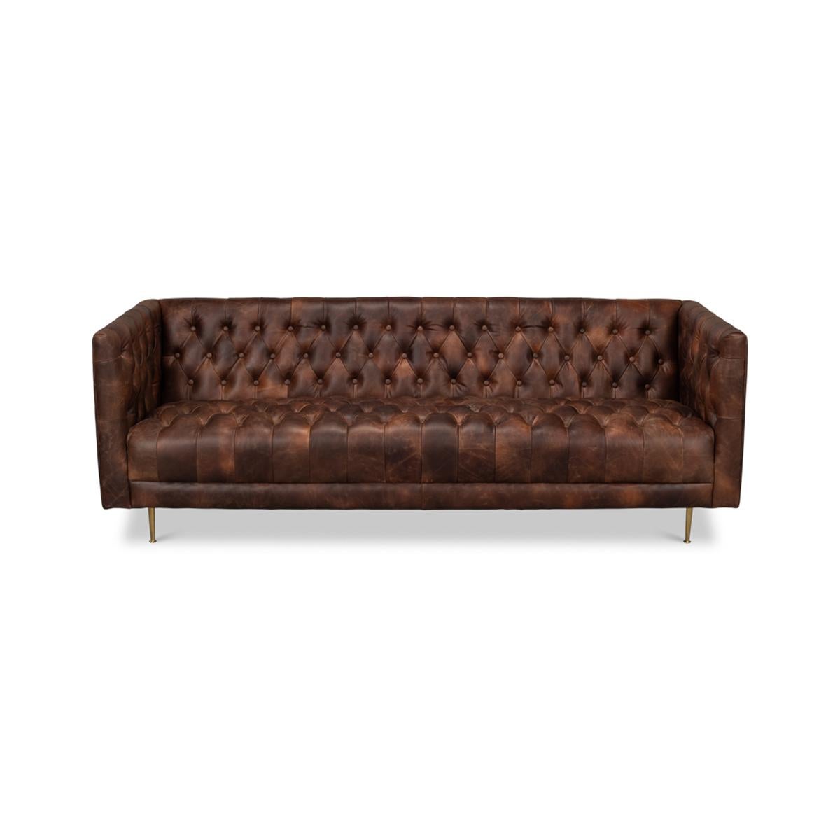Mid-century tufted leather sofa, covered in a beautiful brown traditional top grain leather, mounted on metal legs and scaled to perfection.

Dimensions: 82