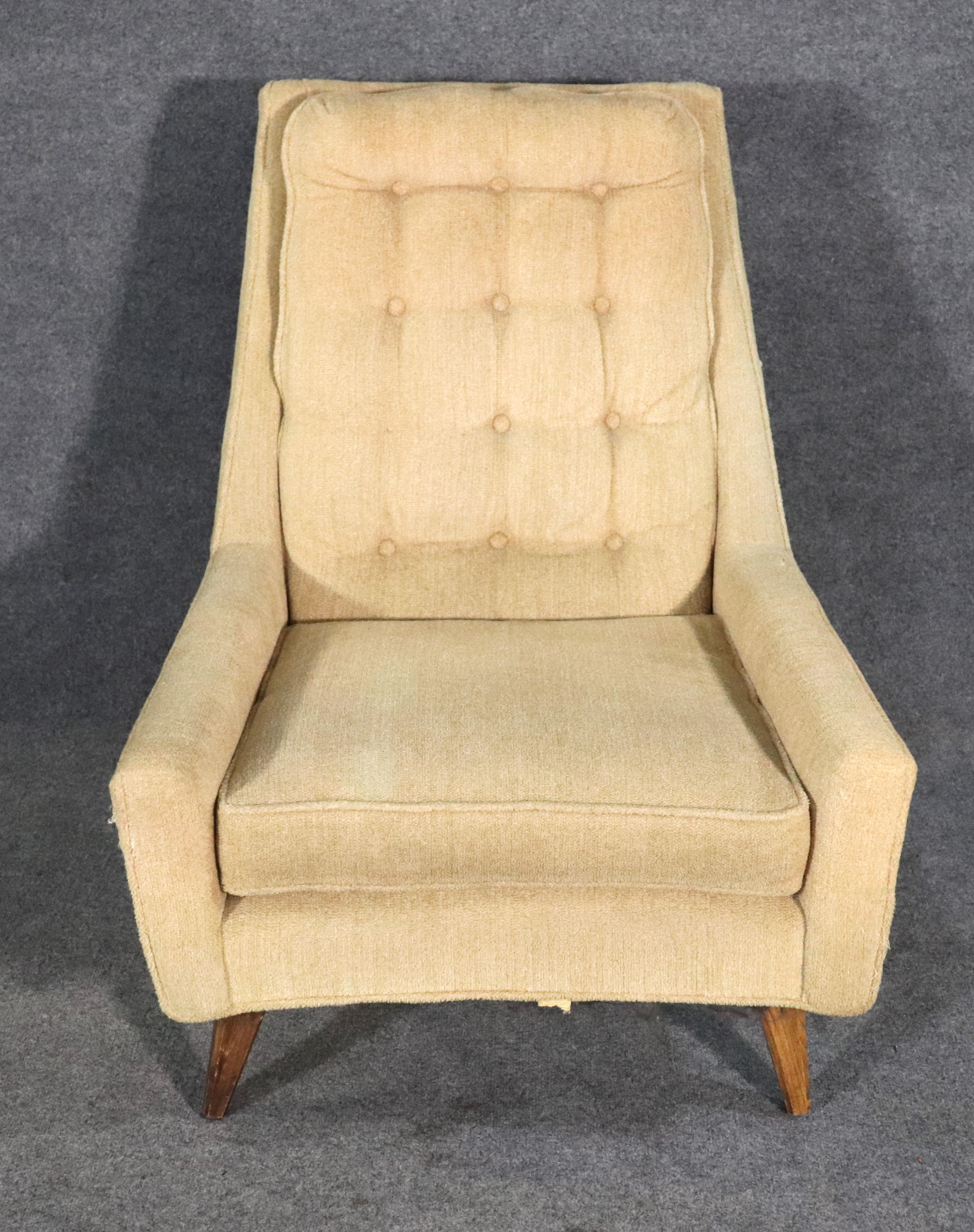 Large mid-century modern lounge chair with tufted back. Vintage armchair fully upholstered on tapered wood legs.
Please confirm location NY or NJ