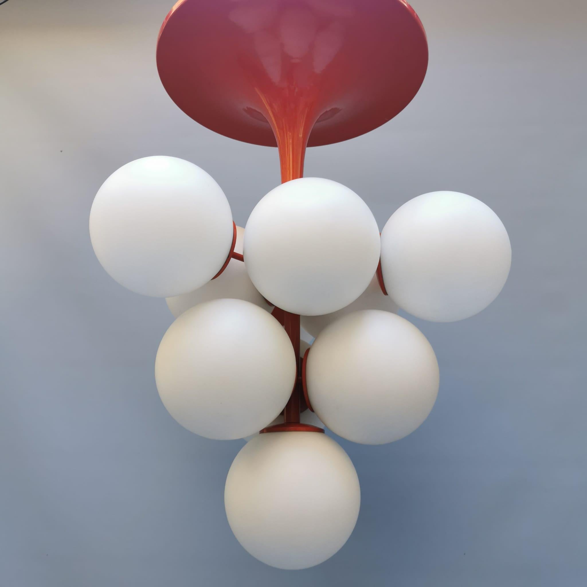 A Swiss-made 1960s chandelier by Temde Leuchten, Switzerland. This lamp consists of ten frosted glass globes and a red enamel metal base and stem. This lamp is a real statement piece, whether turned on or off it attracts easily attention in any