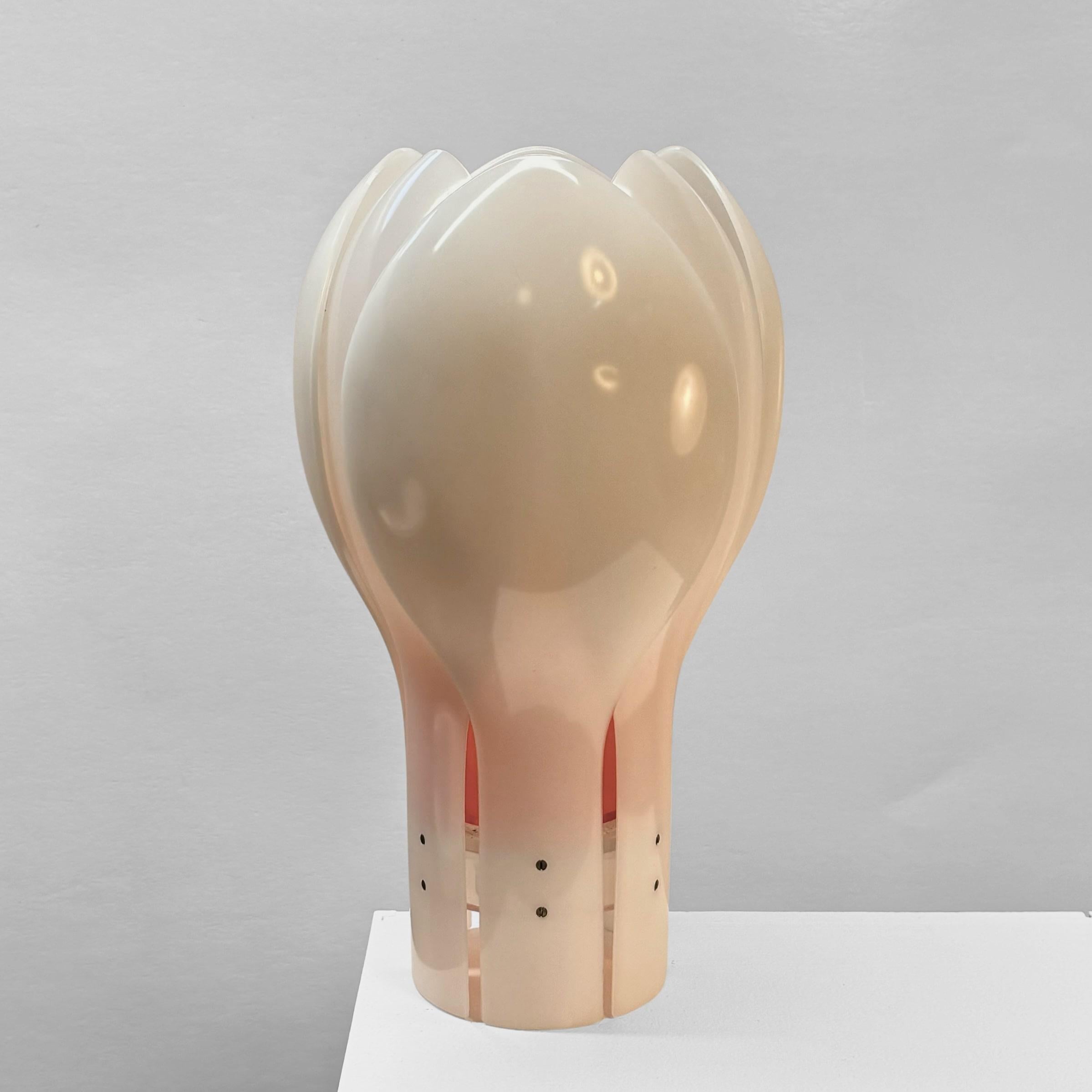 Table lamp ‘Tulip’ designed in the 1970’s by Swedish architect Yngve Ekström. Made from white acrylic with clear details. It features an orange inner shade that imparts a warm and cozy tone to the light. Electrified with one lamp holder inside the