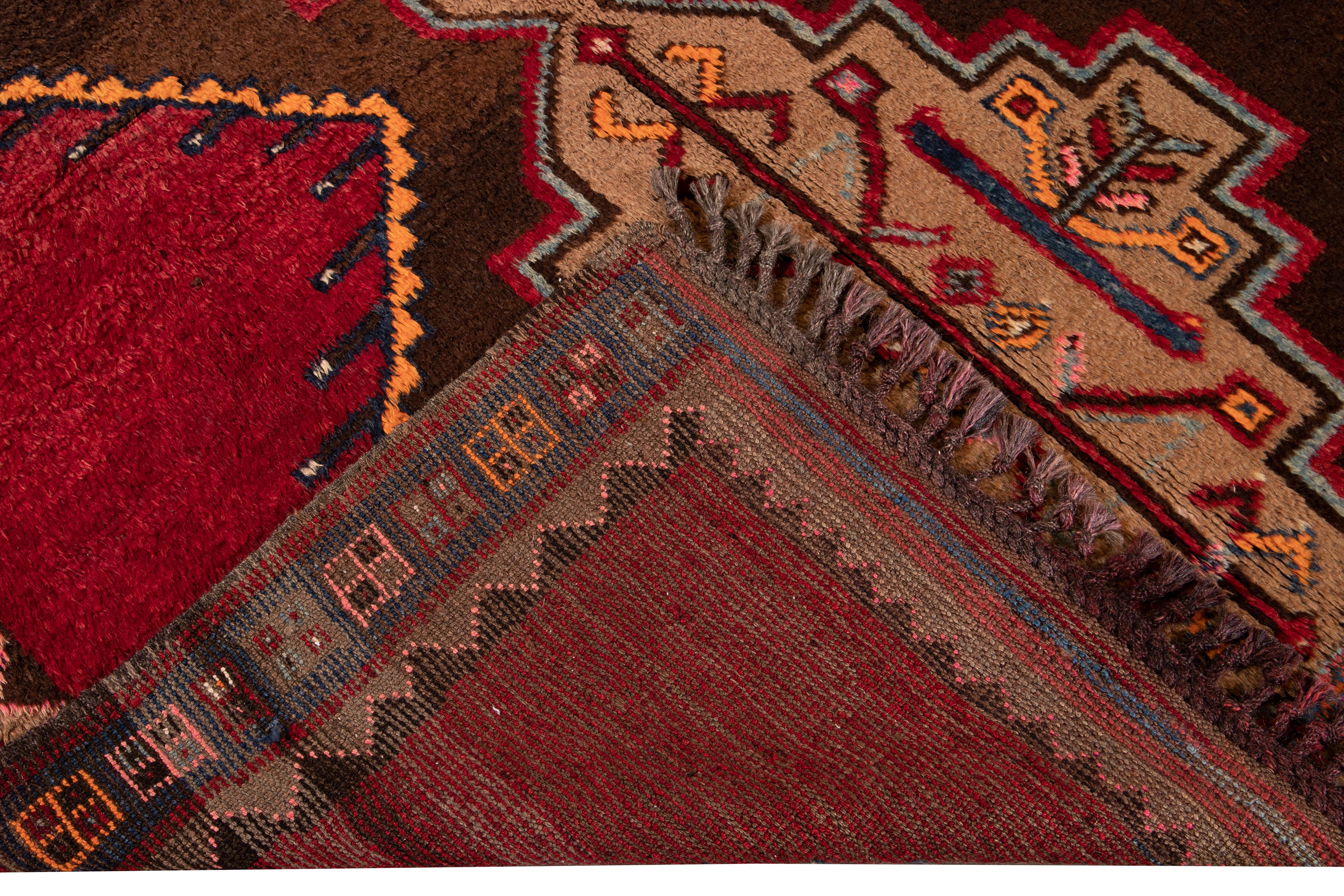 Beautiful vintage Turkish hand knotted wool rug with a red and orange field. This Turkish rug has a brown frame and multi-color gorgeous all-over geometric Tribal design.

This rug measures: 6' x 9'3