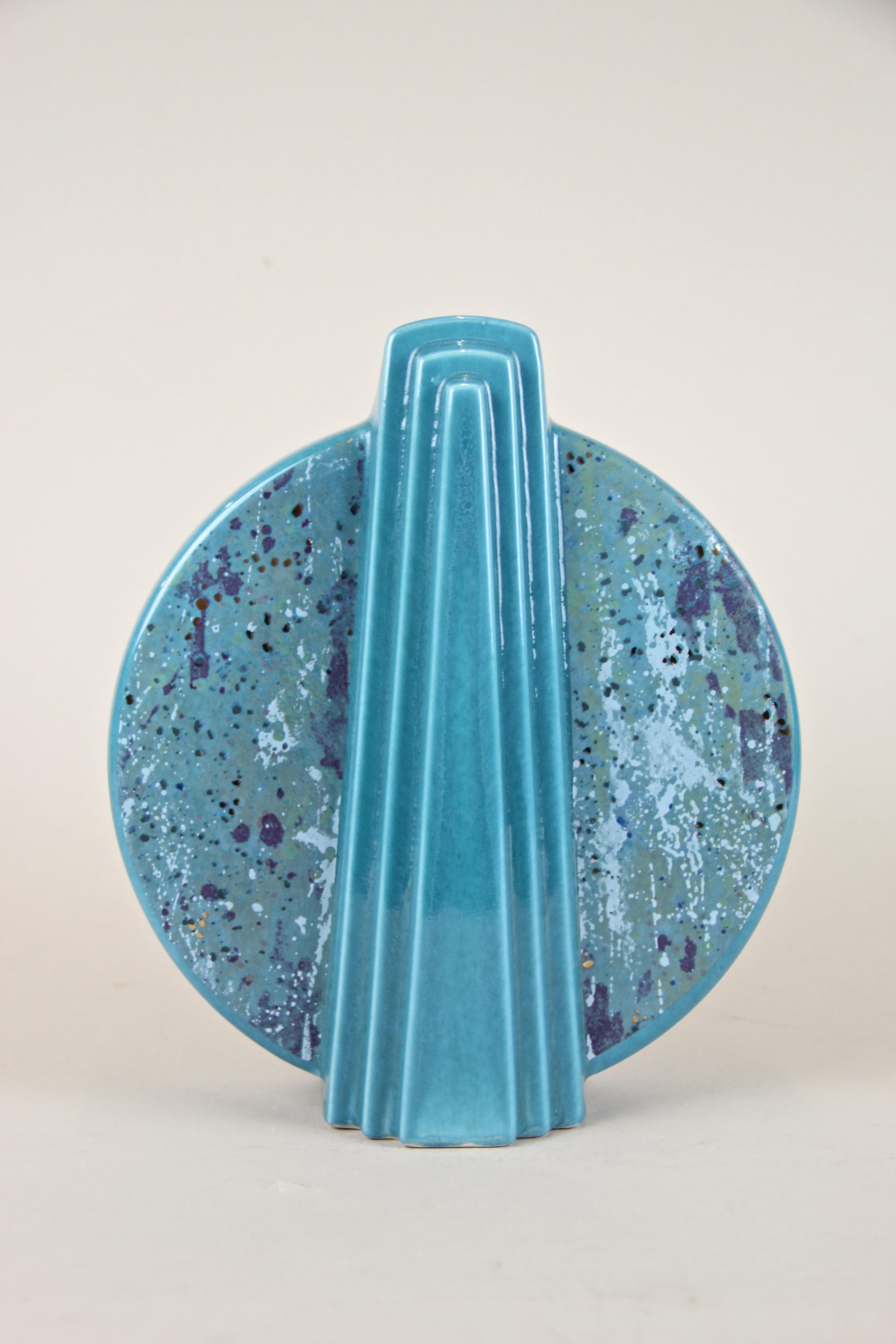 Decorative midcentury ceramic Vase out of Germany from circa 1950. The very special shaped body, reminding of the famous Art Deco era, shows a beautiful turquoise glazed surface adorned by a very unique splattered design in purple, light blue, green