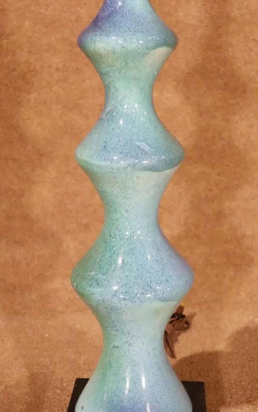 Mid-Century Modern table lamp in shades of turquoise. Sculpted ceramic shape on a black wood block.
Please confirm location.