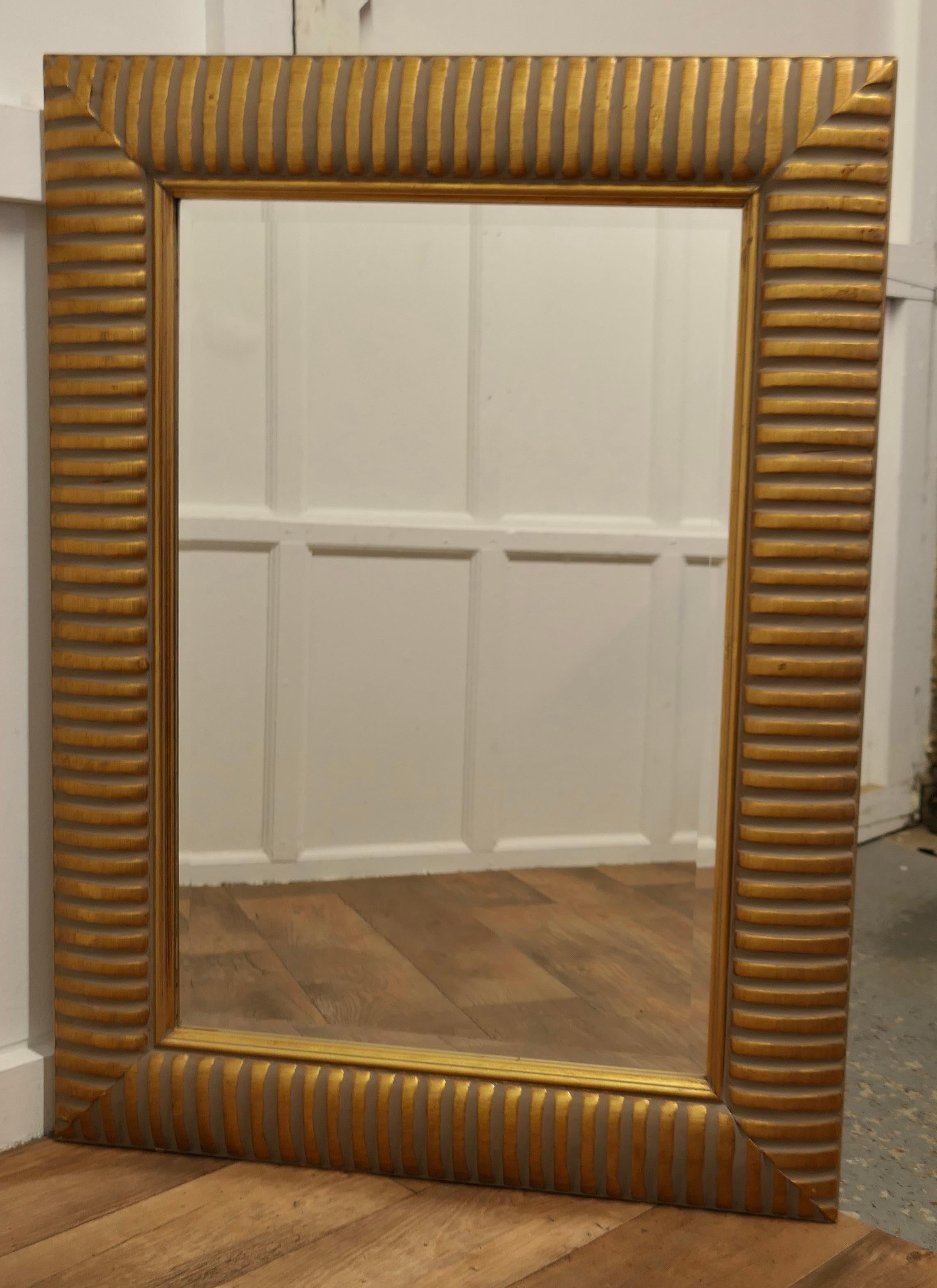 Mid Century Tutankhamun Inspired Wall Mirror

This is a large and very attractive piece, taking its inspiration for the 1960s enthusiasm for all things Egyptian 
The tall mirror is framed with a giant Gold stripe 6” wide frame, it has a bevelled